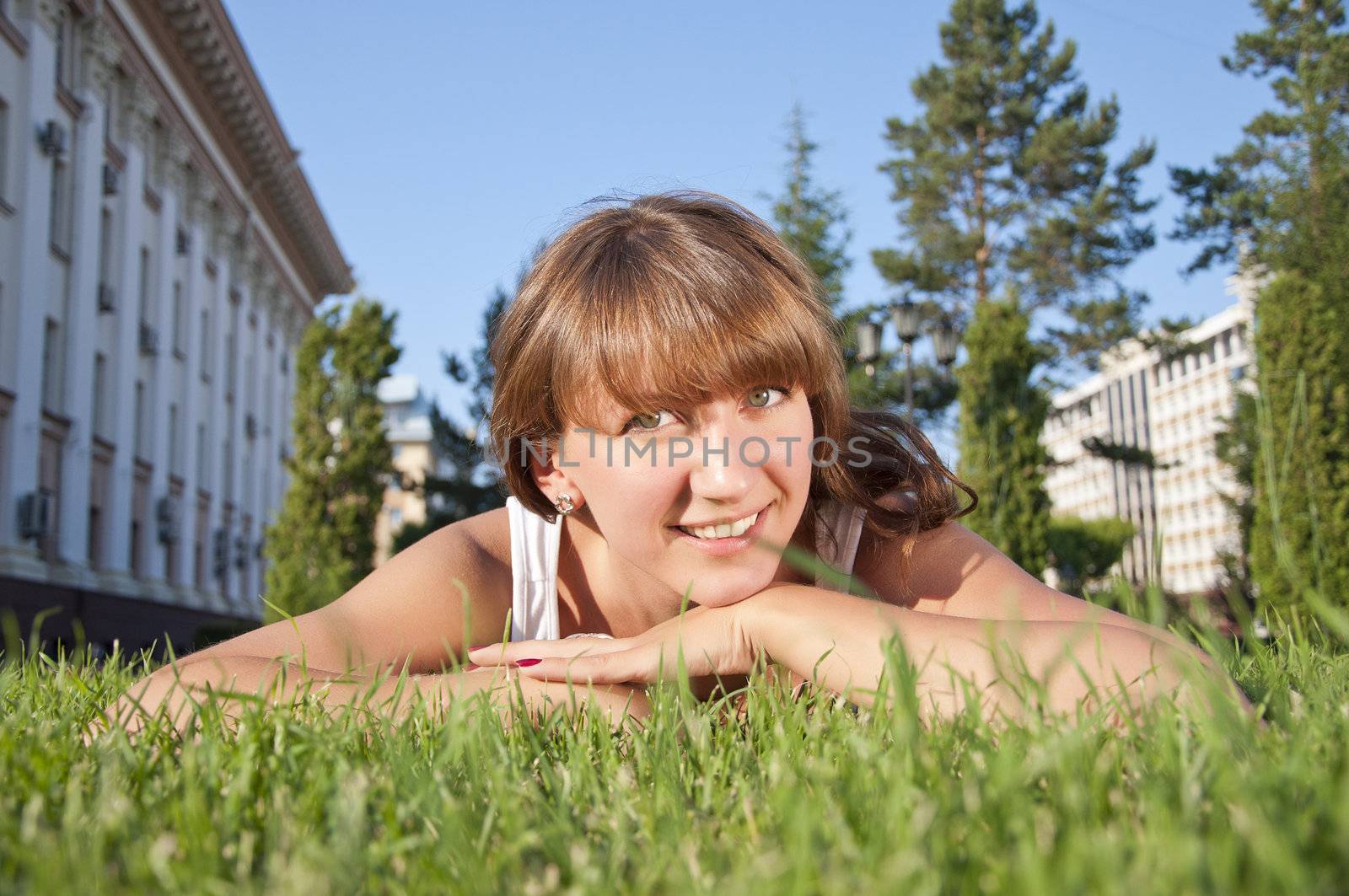 beautiful young woman smiling on grass field by adam121