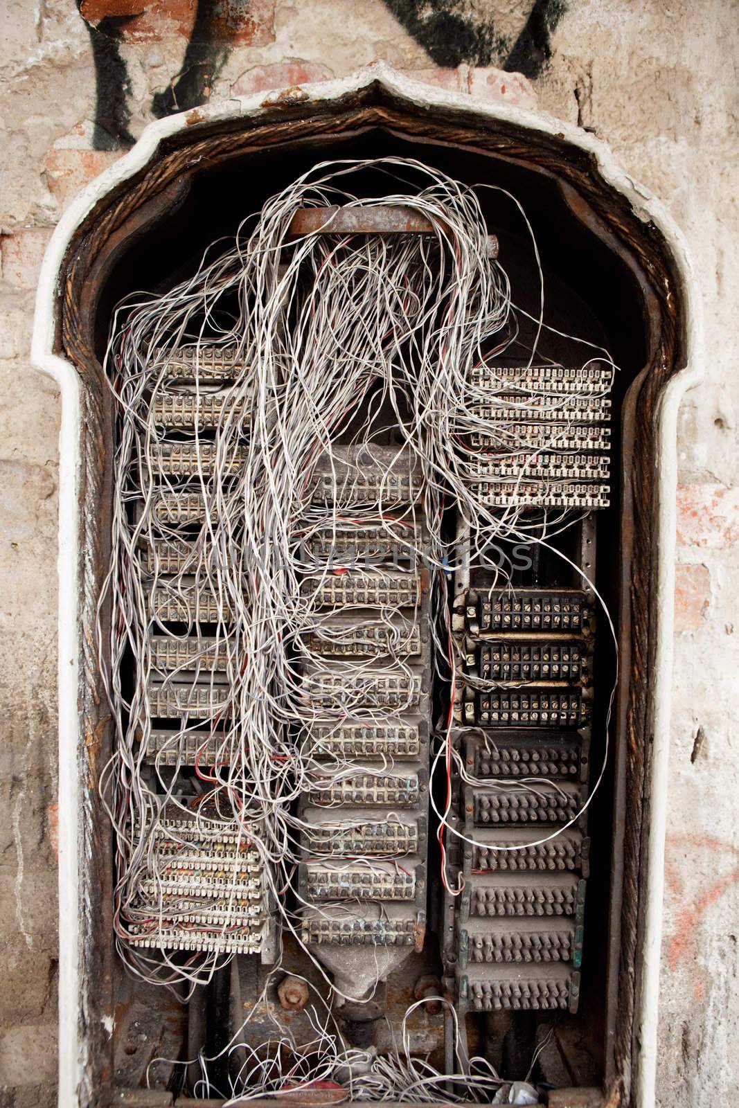 An old telephone central box with many wires exposed