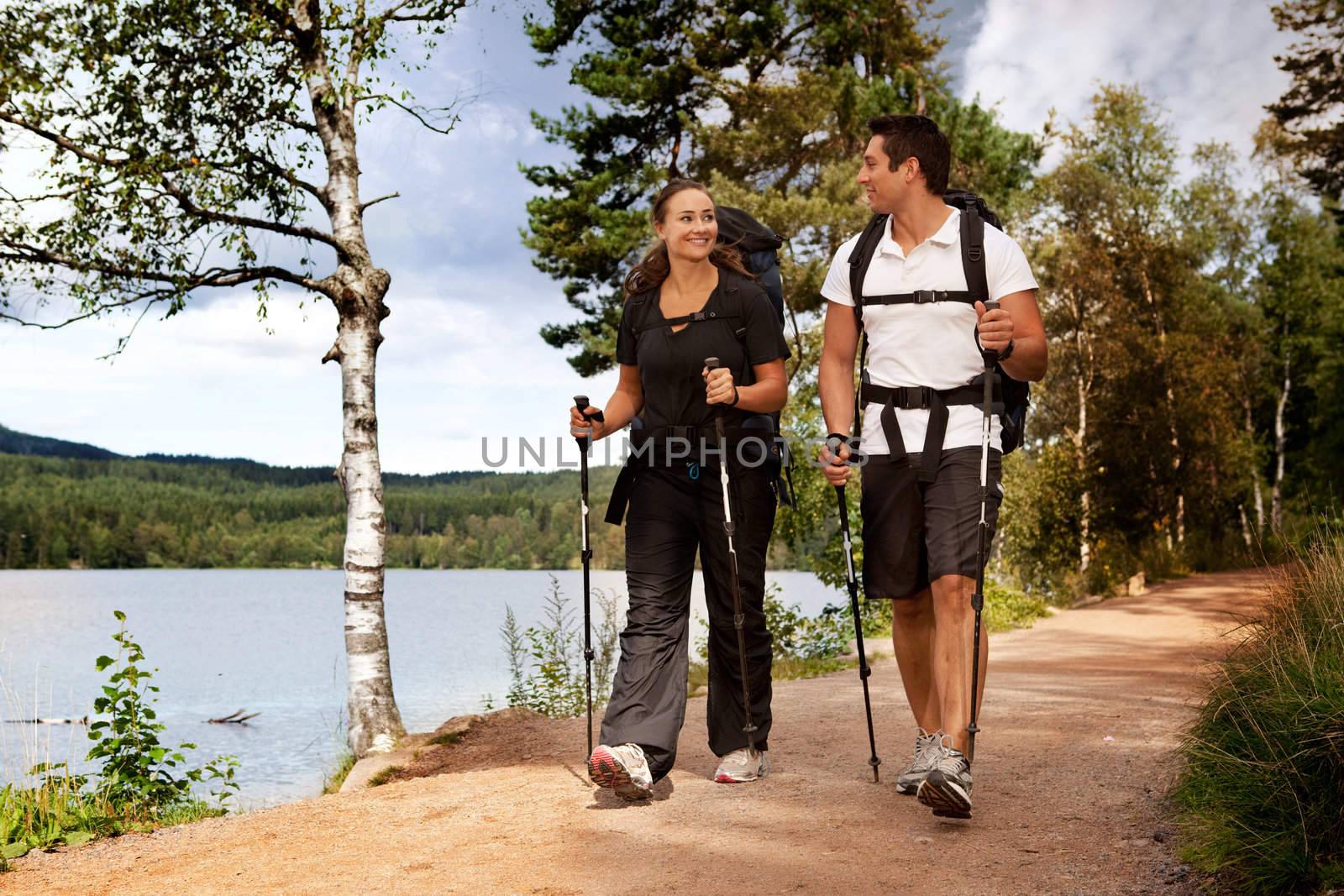 A couple walking on trail with backpacks