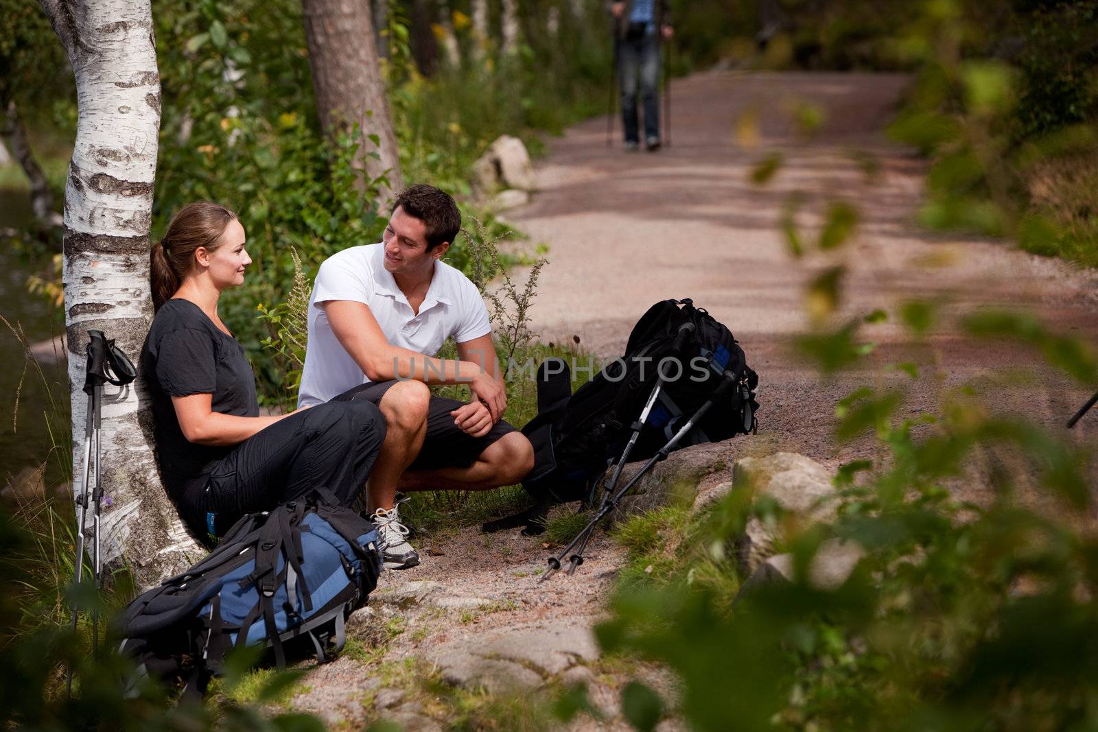 A couple take a break while backpacking on a prepared trail