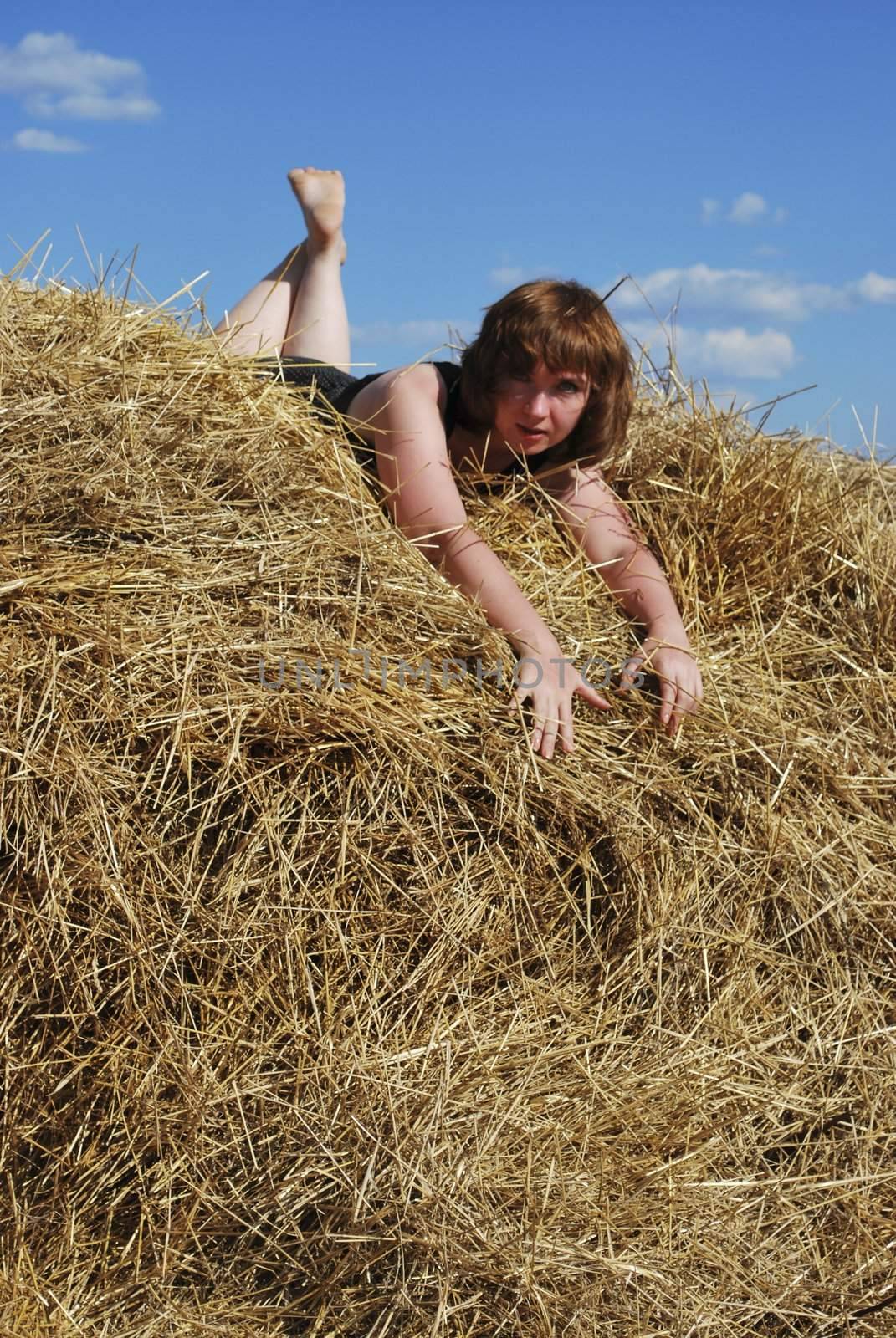 haystack and young woman on distant plan