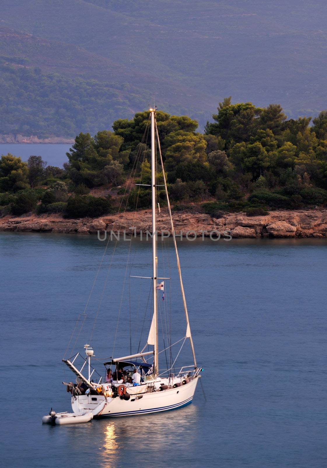 Sailing boat at dusk, anchored in a serene location in the Mediterranean