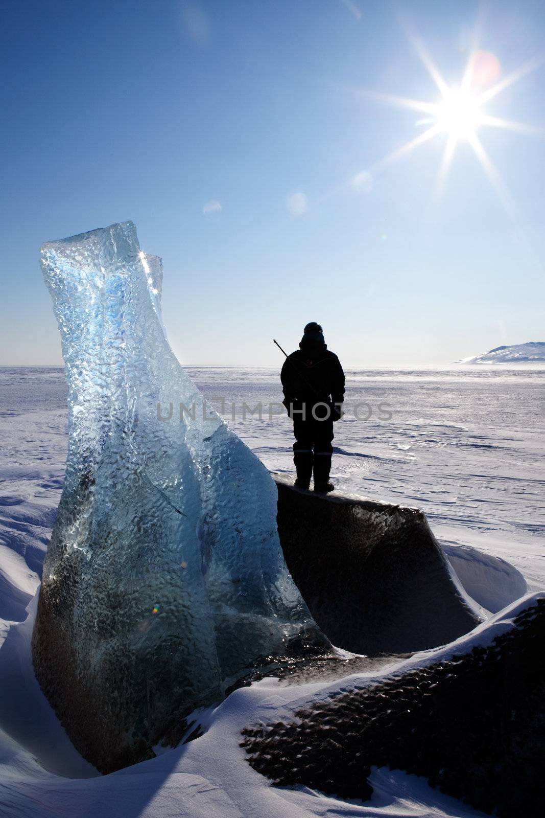 An adventure guide looks onto the horizon on the east coast of Spitsbergen, Svalbard, Norway