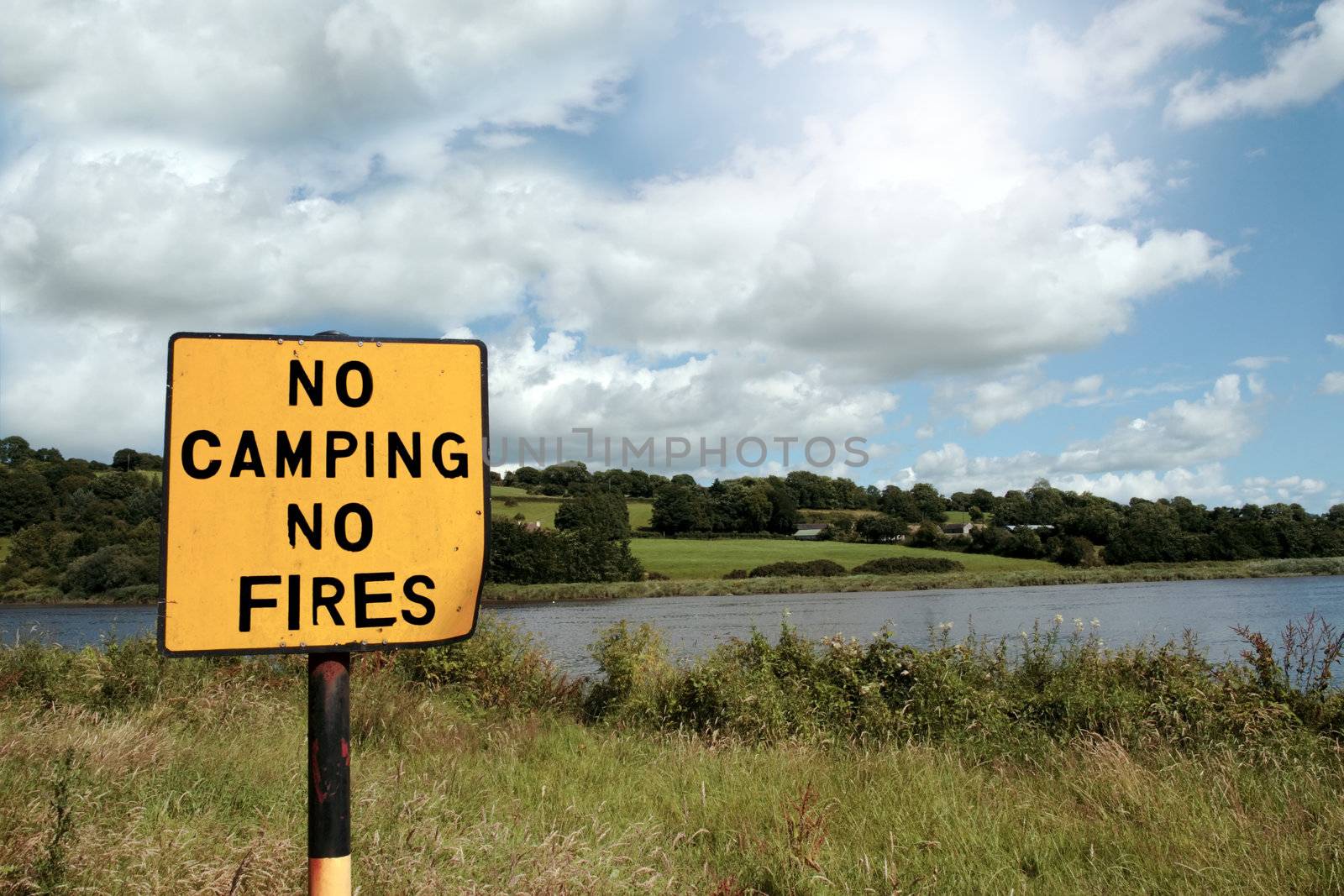 a no camping no fires sign in knockanore county waterford in the south of ireland in summer on the blackwater river edge