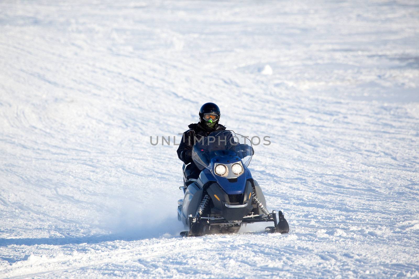 A snowmobile isolated against a winter snow landscape