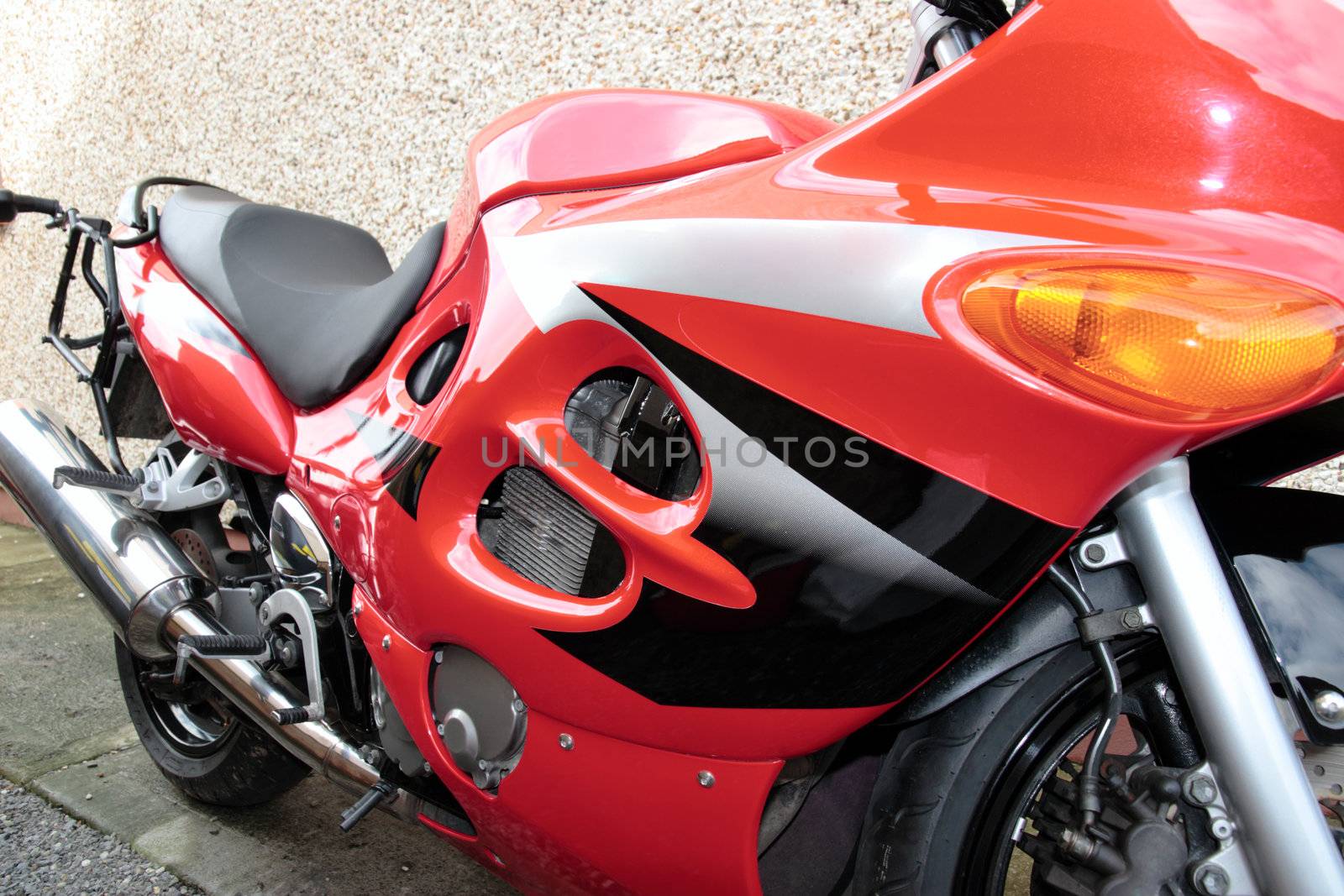 a parked red super sports motor bike