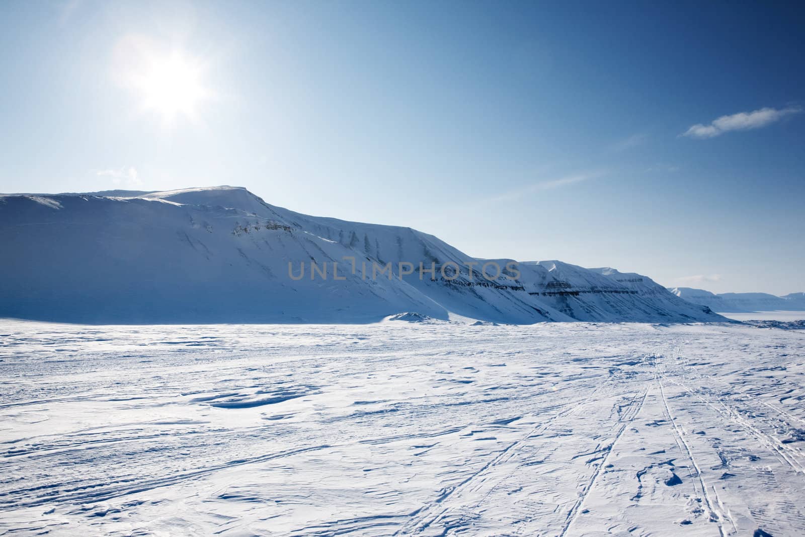 A beautiful winter landscape with a mountain and deep blue sky