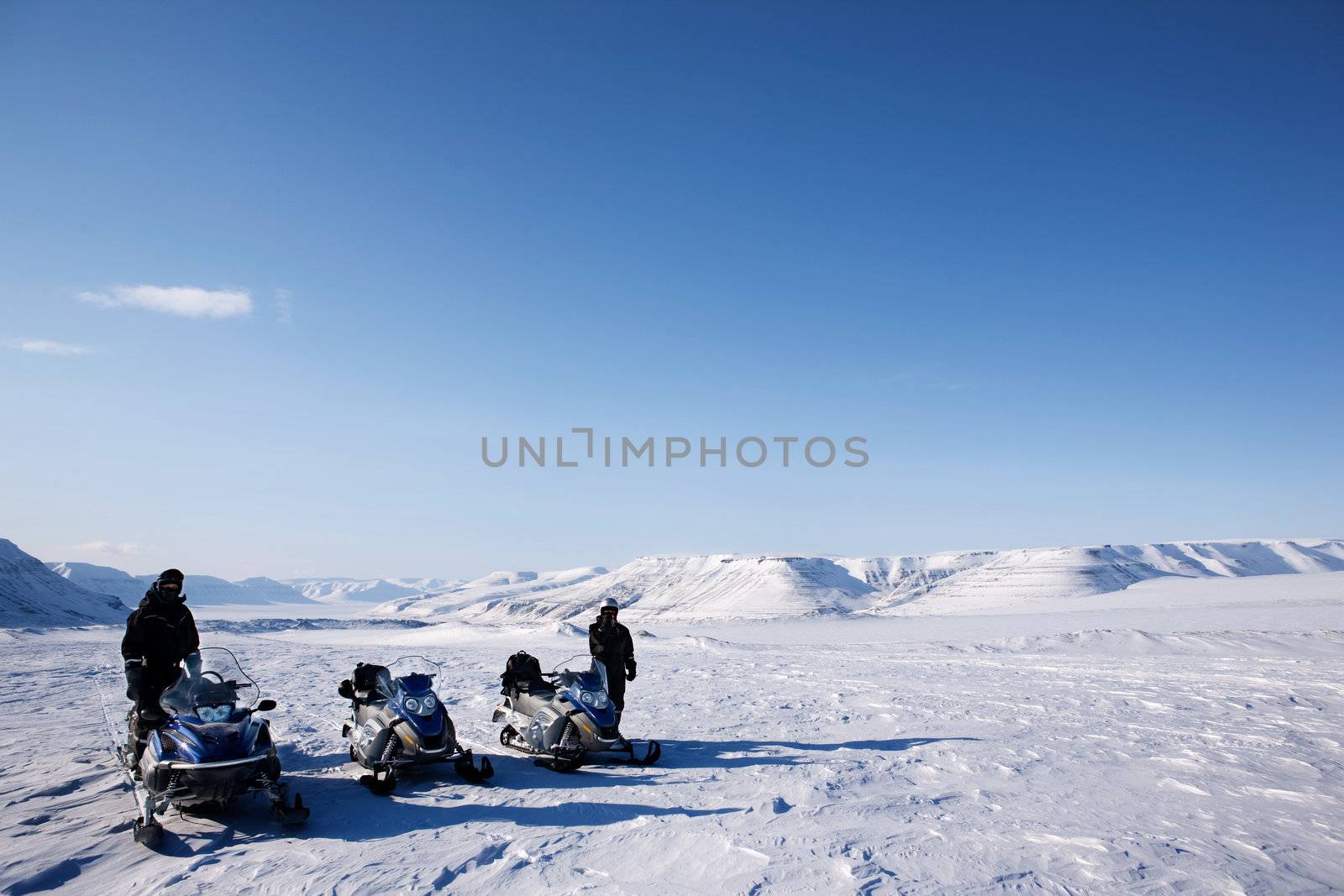 A group of people on a snowmobile trip in a winter landscape