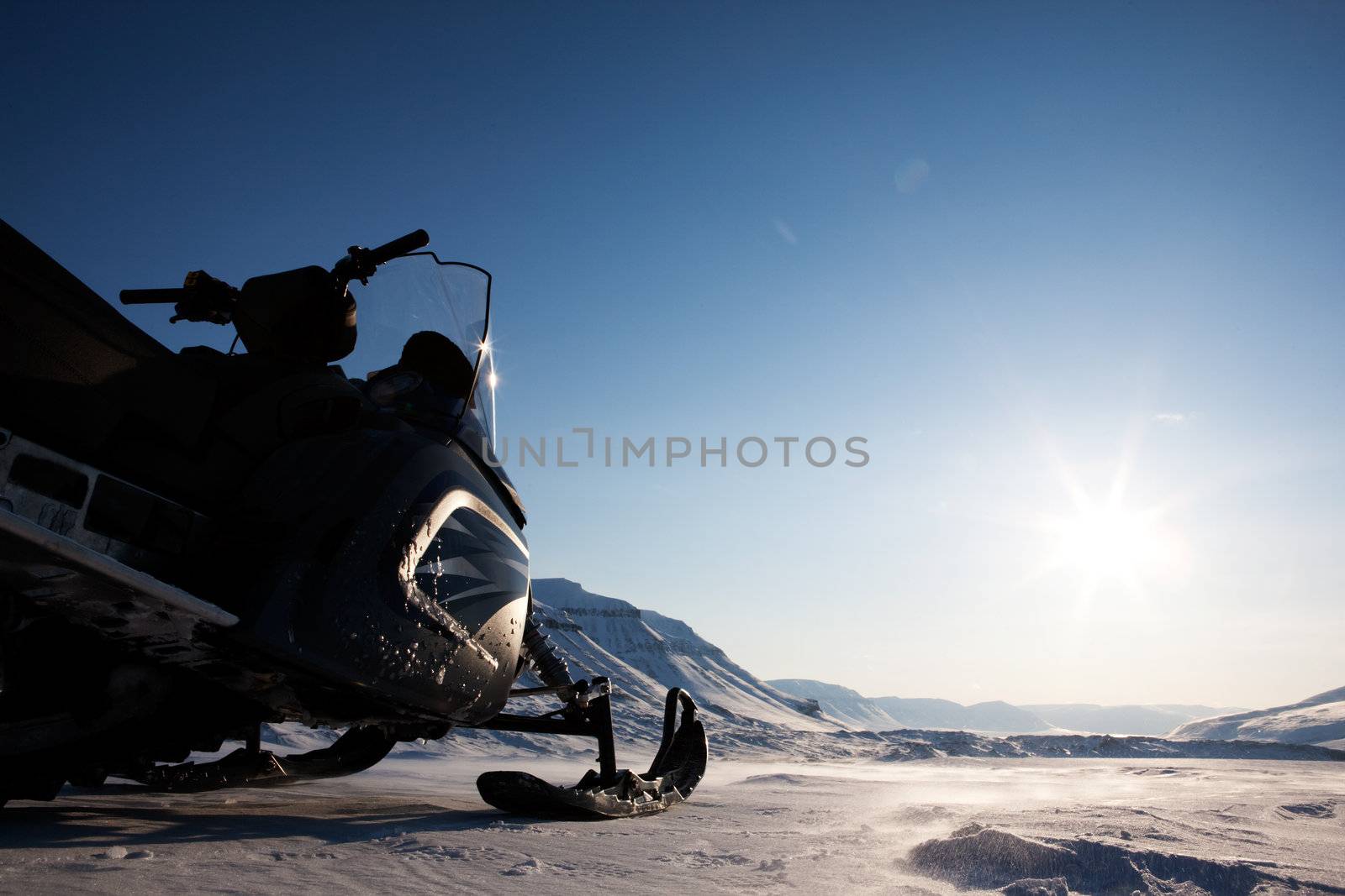 A snowmobile detail on a barren winter landscape
