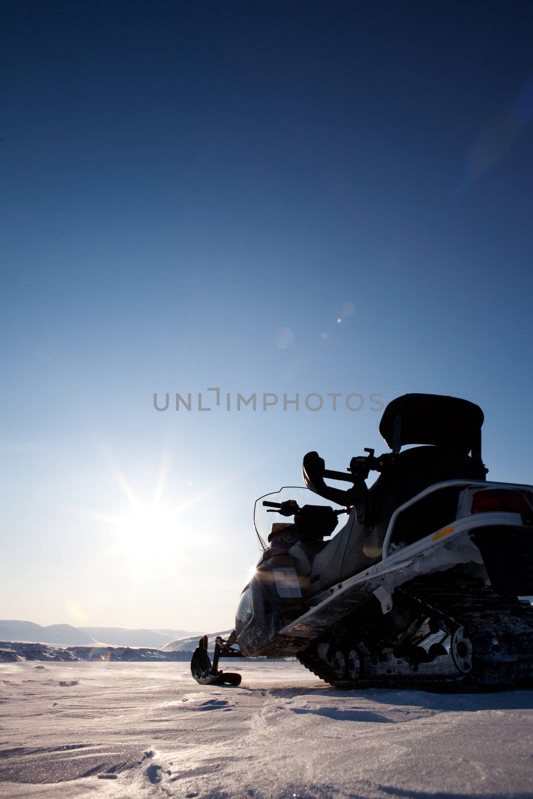 A snowmobile detail on a barren winter landscape