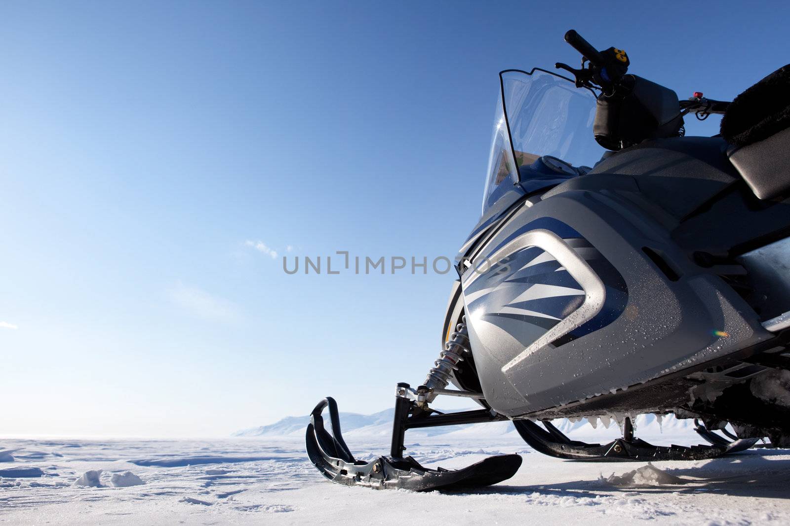 A snowmobile detail on a barren winter landscape