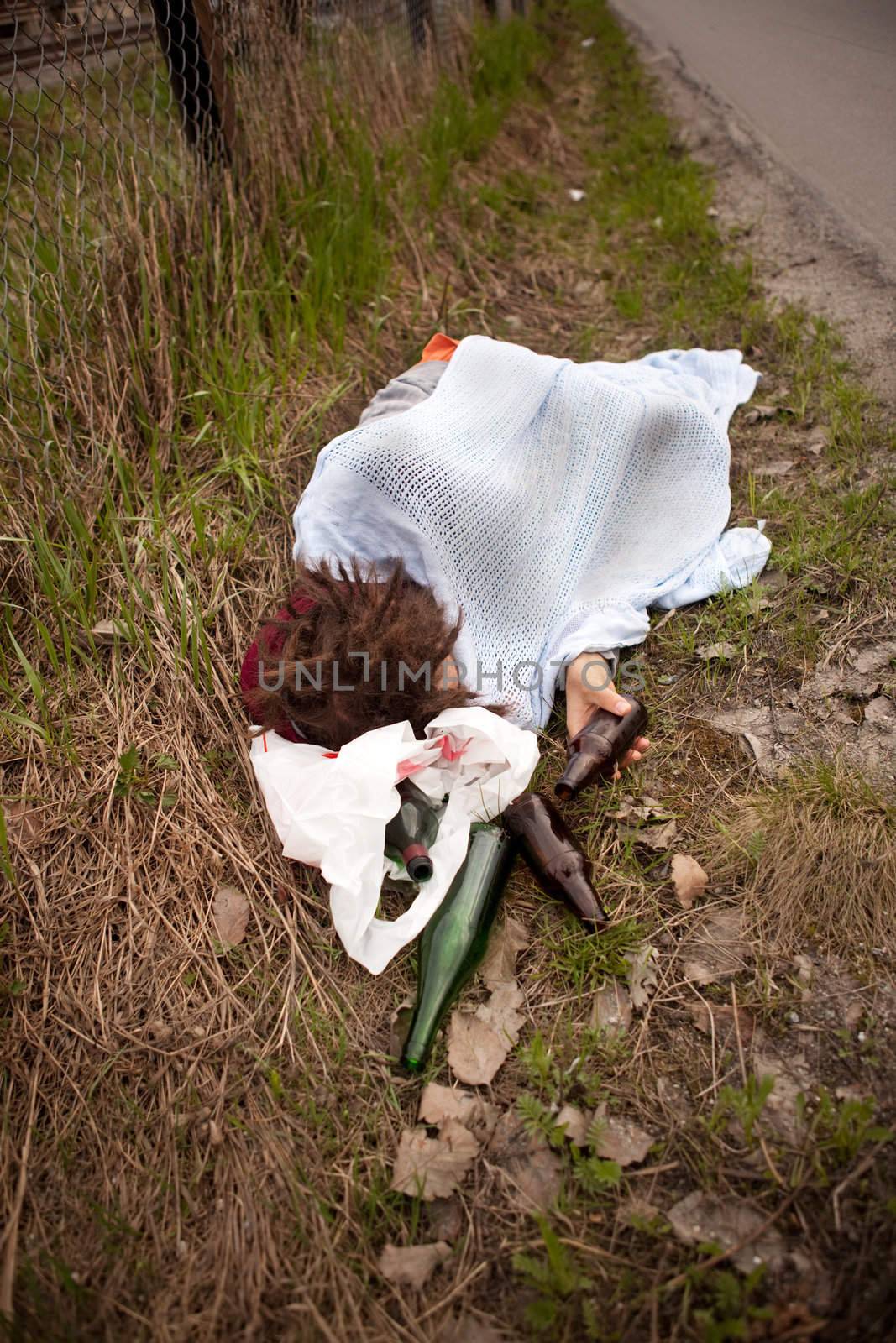 A homeless person sleeping in the ditch