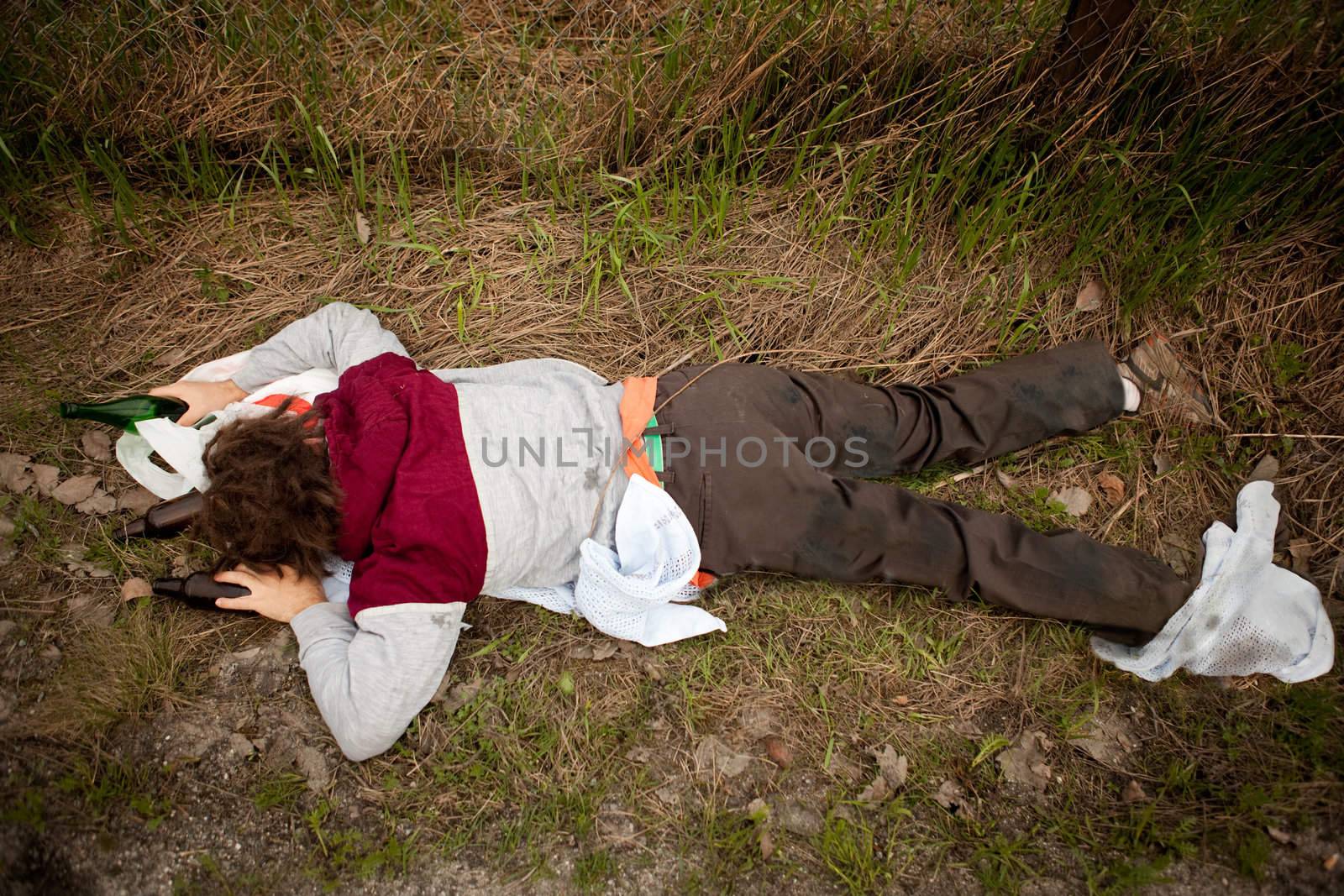 A drunk homeless man laying the ditch