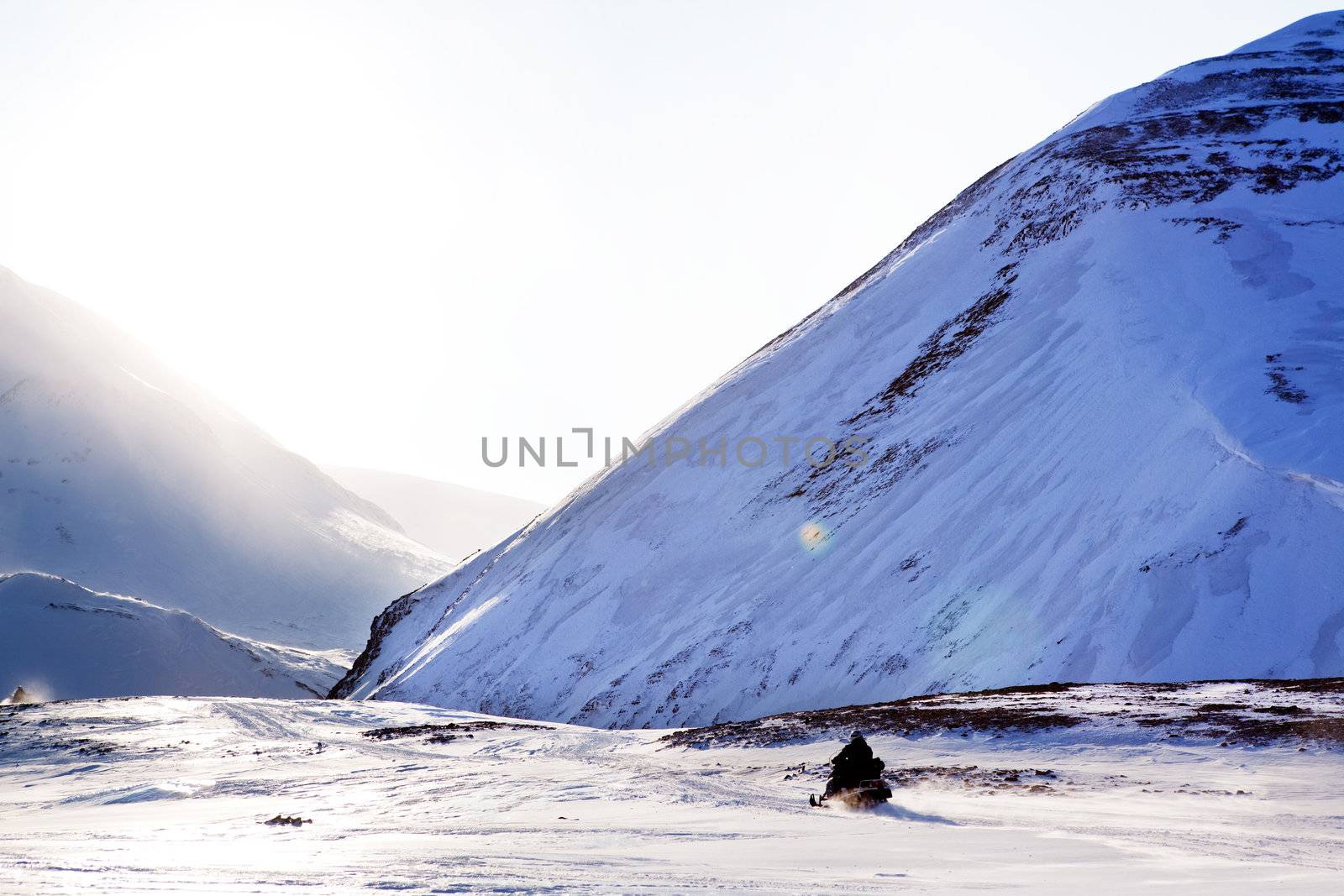 A snowmobile on a beautiful winter mountain landscape