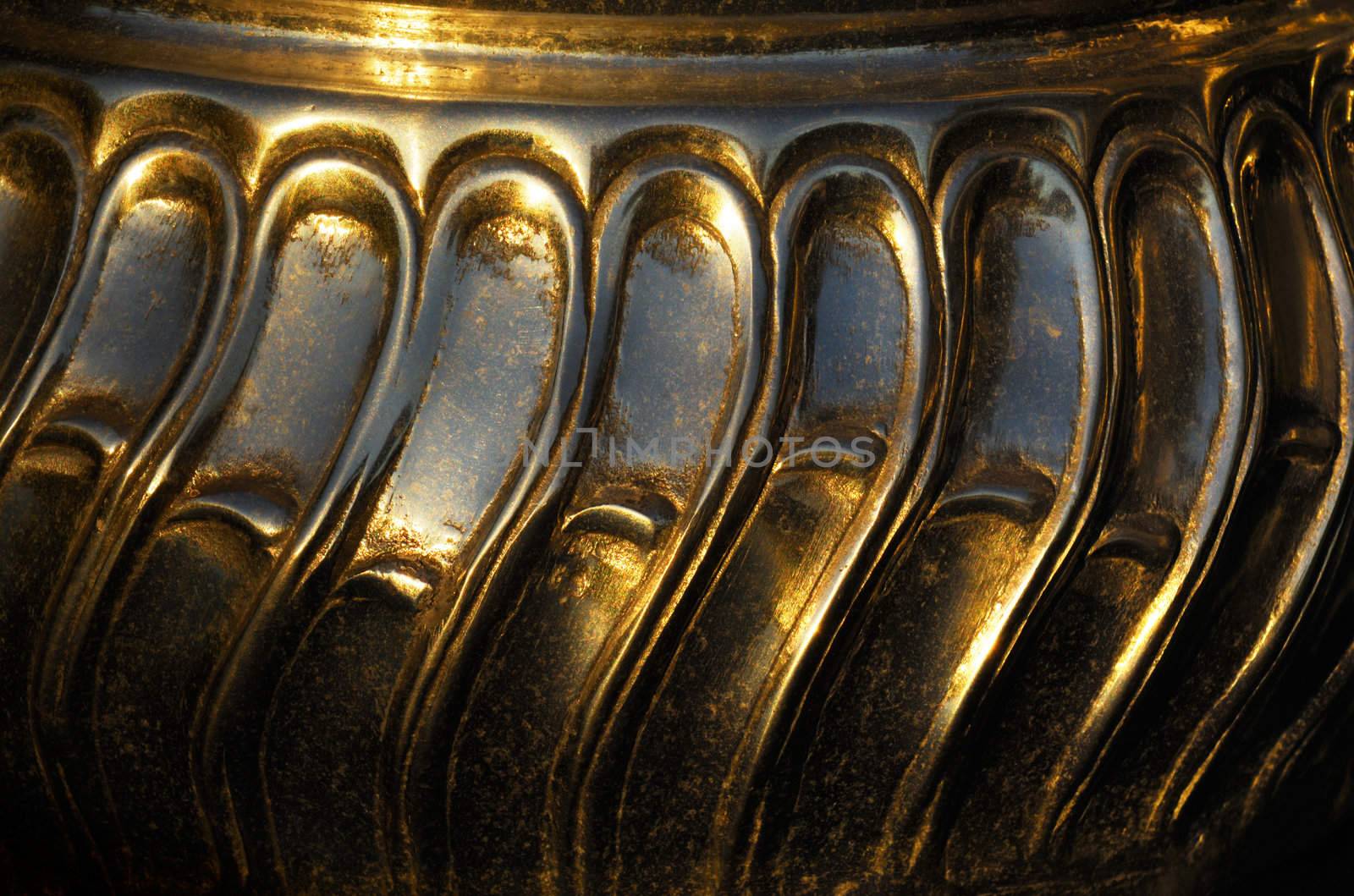 Close-up shot of an antique metallic fruit bowl with an interesting pattern design