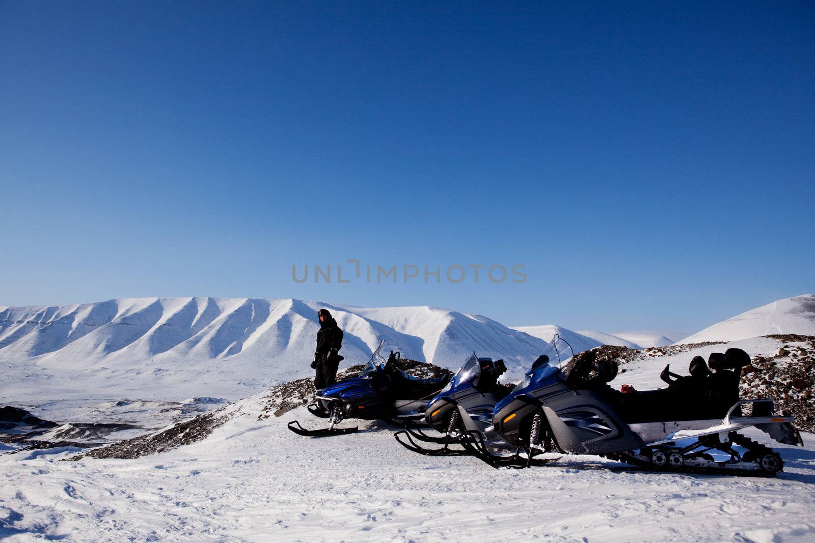 Snowmobiles in a barren winter landscape, Svalbard, Norway