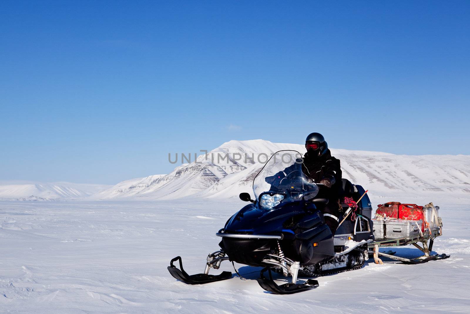 A snowmobile on an arctic expedition on a frozen lake