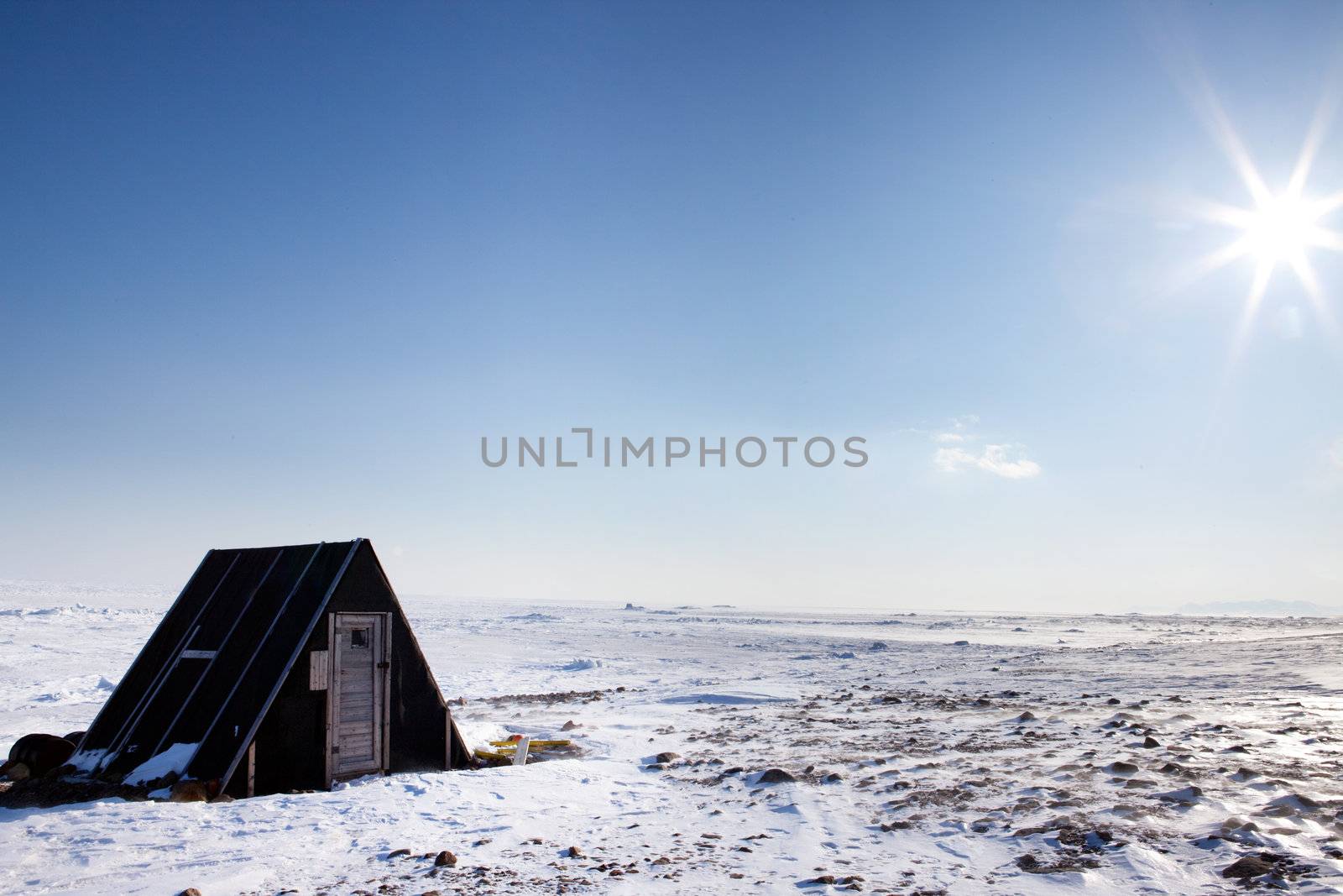 A small winter shelter on the frozen coast of Spitsbergen Island, Svalbard, Norway