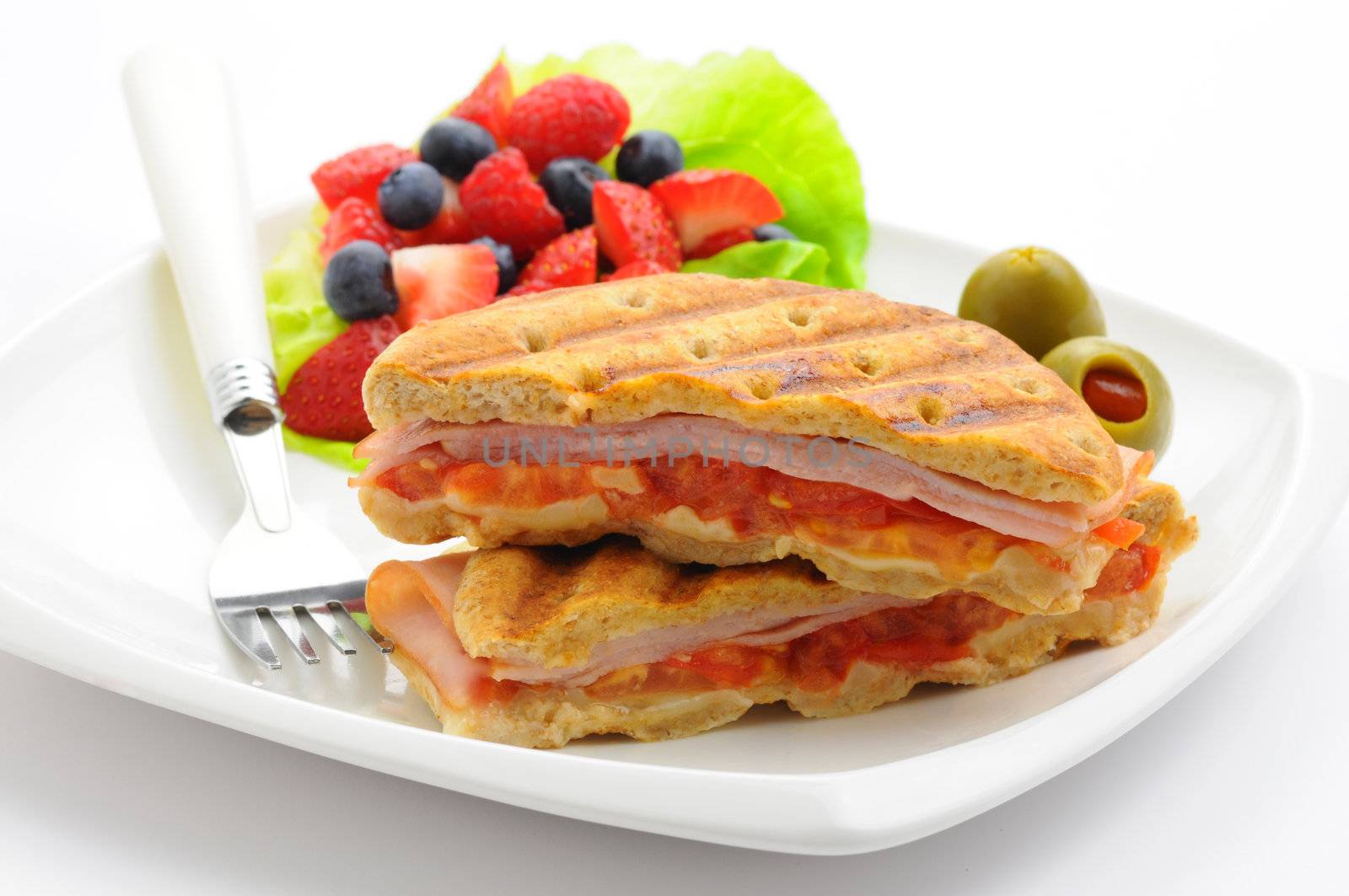 Delicious breakfast panini served with fresh fruit.