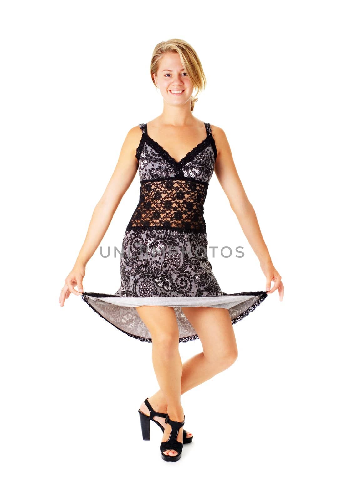 Young woman in a dress posing against a white background.