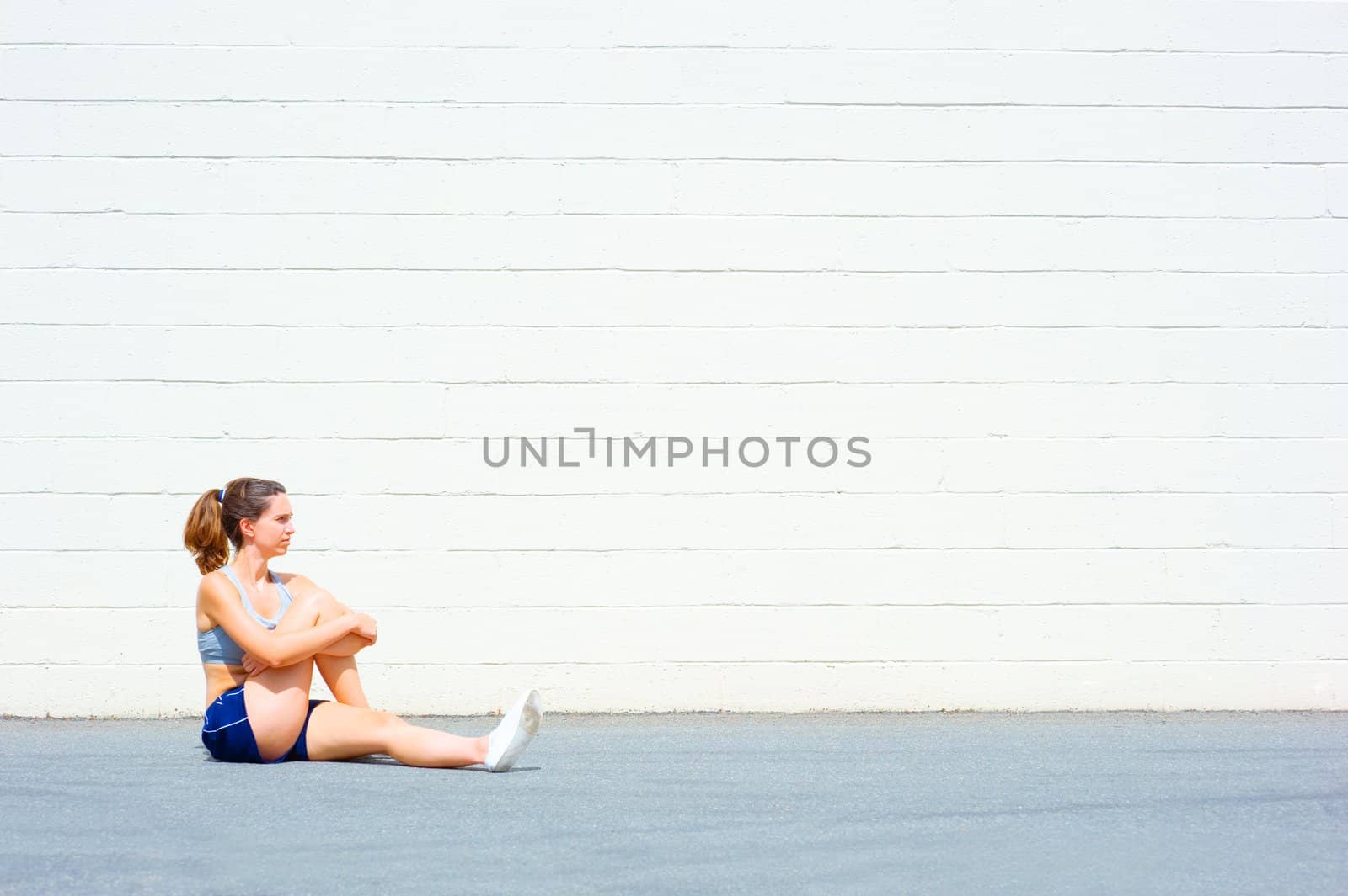 Mature woman working out in an urban setting, from a complete set of photos.