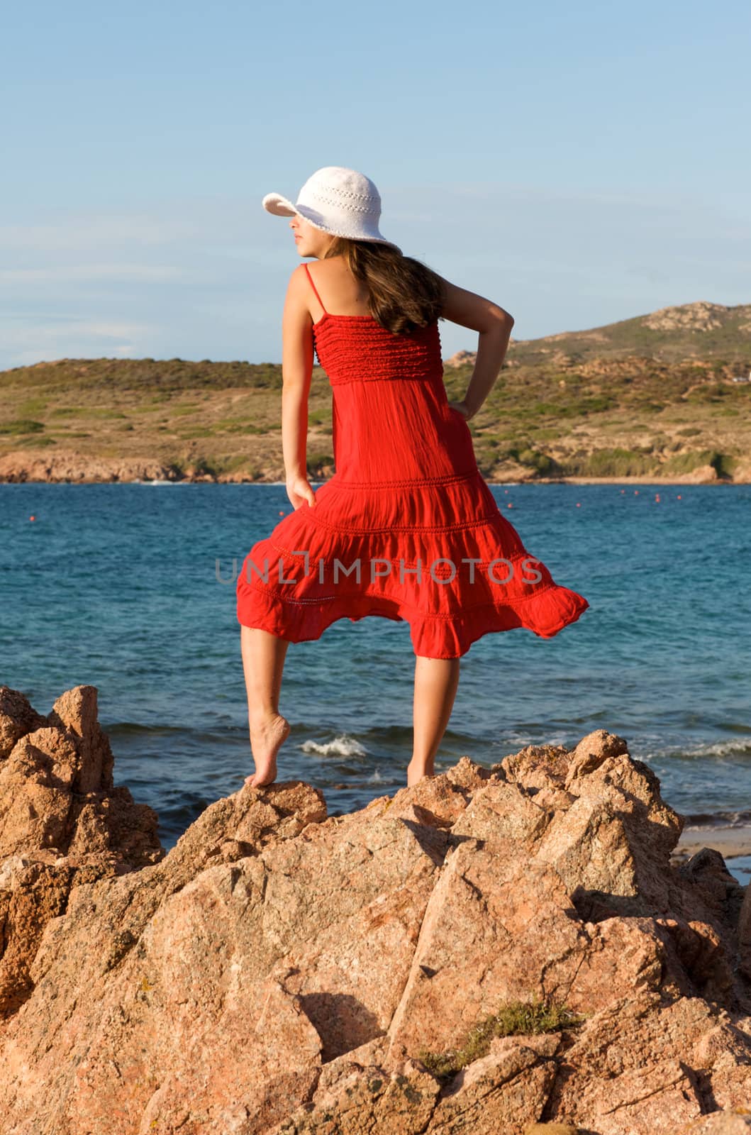 Pretty girl posing on the beach during her vacation