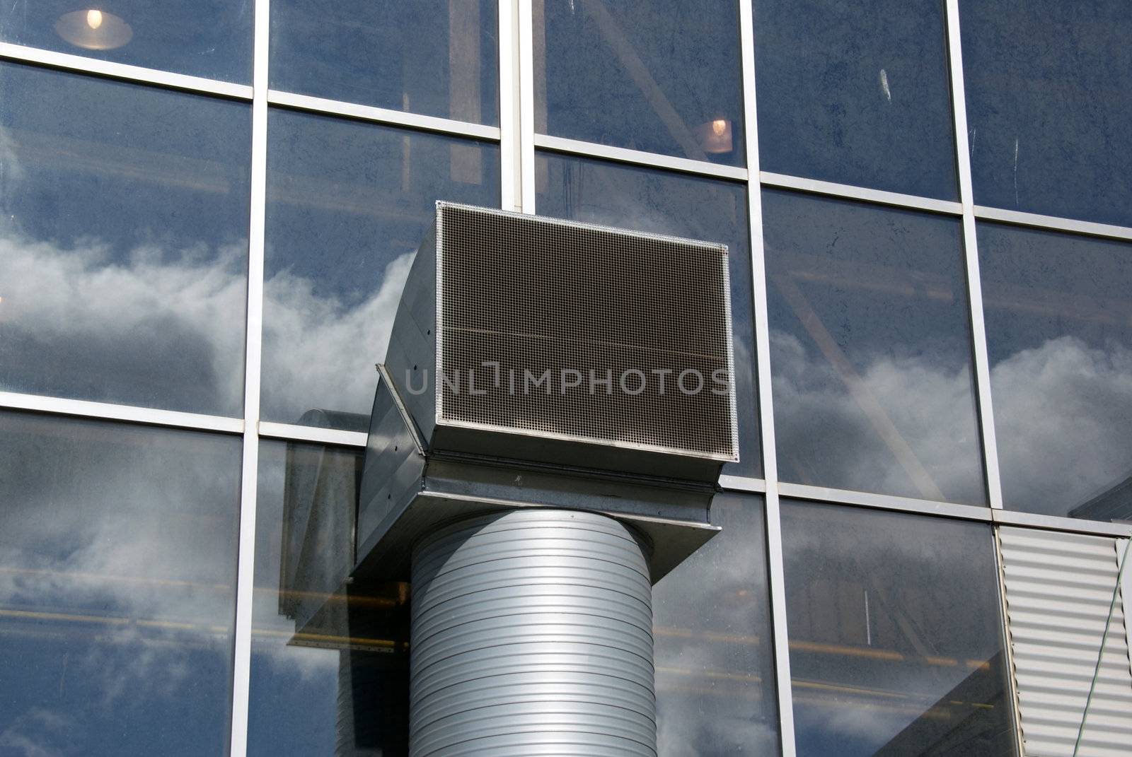 Ventilation pipe is located near a wall of glass