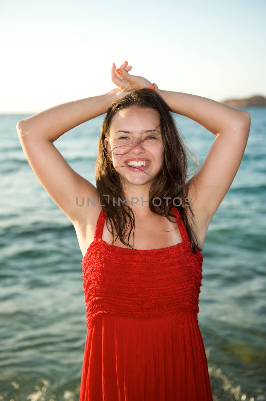 retty young woman relaxing on the beach with a free feeling