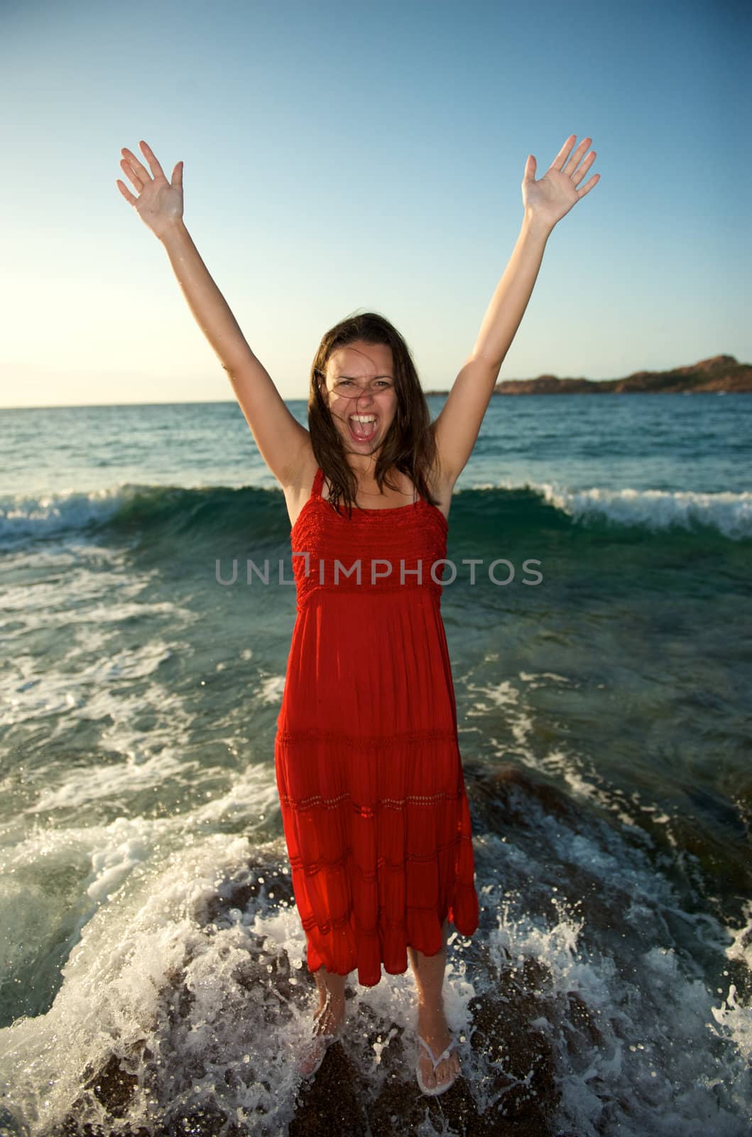 retty young woman relaxing on the beach with a free feeling