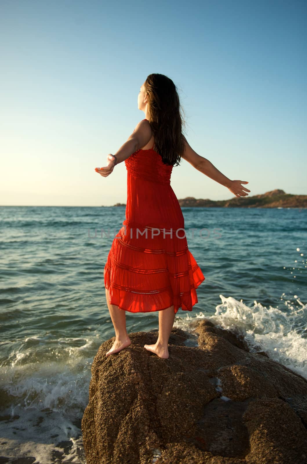 retty young woman relaxing on the beach with a free feeling