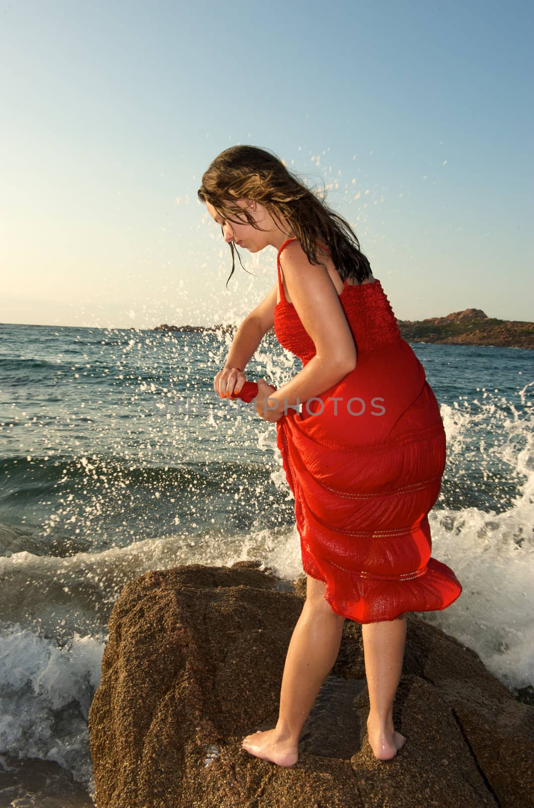 retty young woman relaxing on the beach with a free feeling