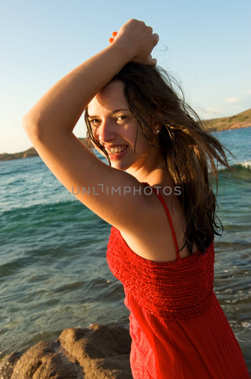 retty young woman relaxing on the beach with a free feeling