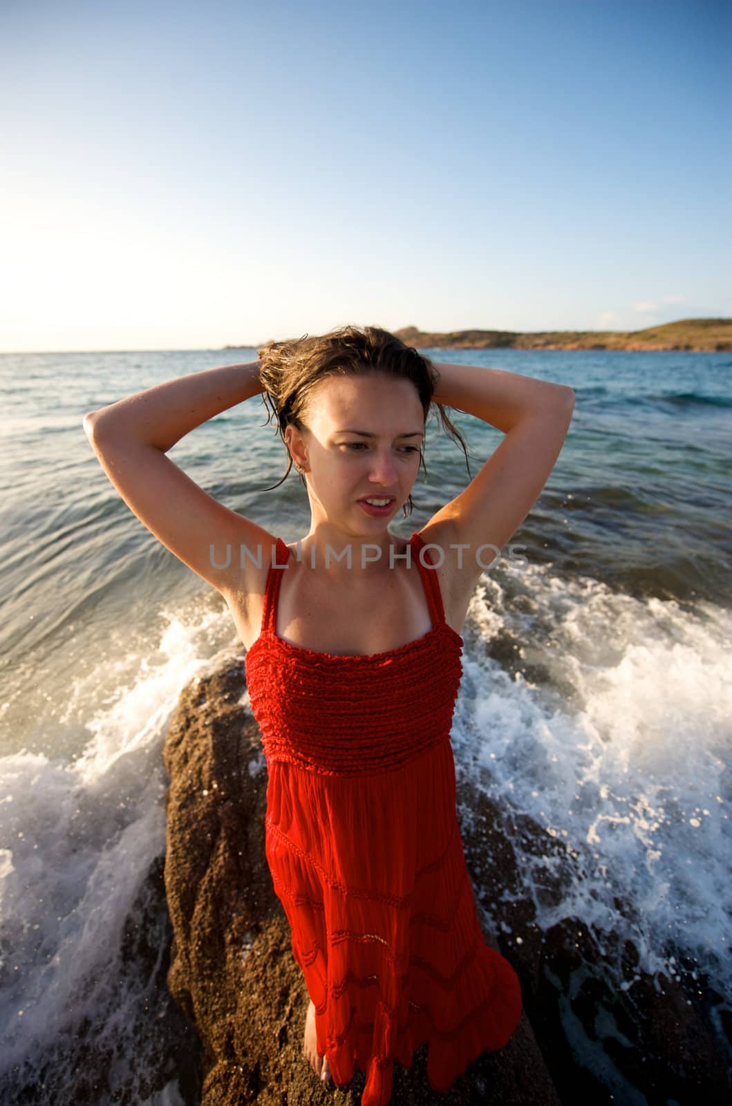 retty young woman relaxing on the beach with a free feeling