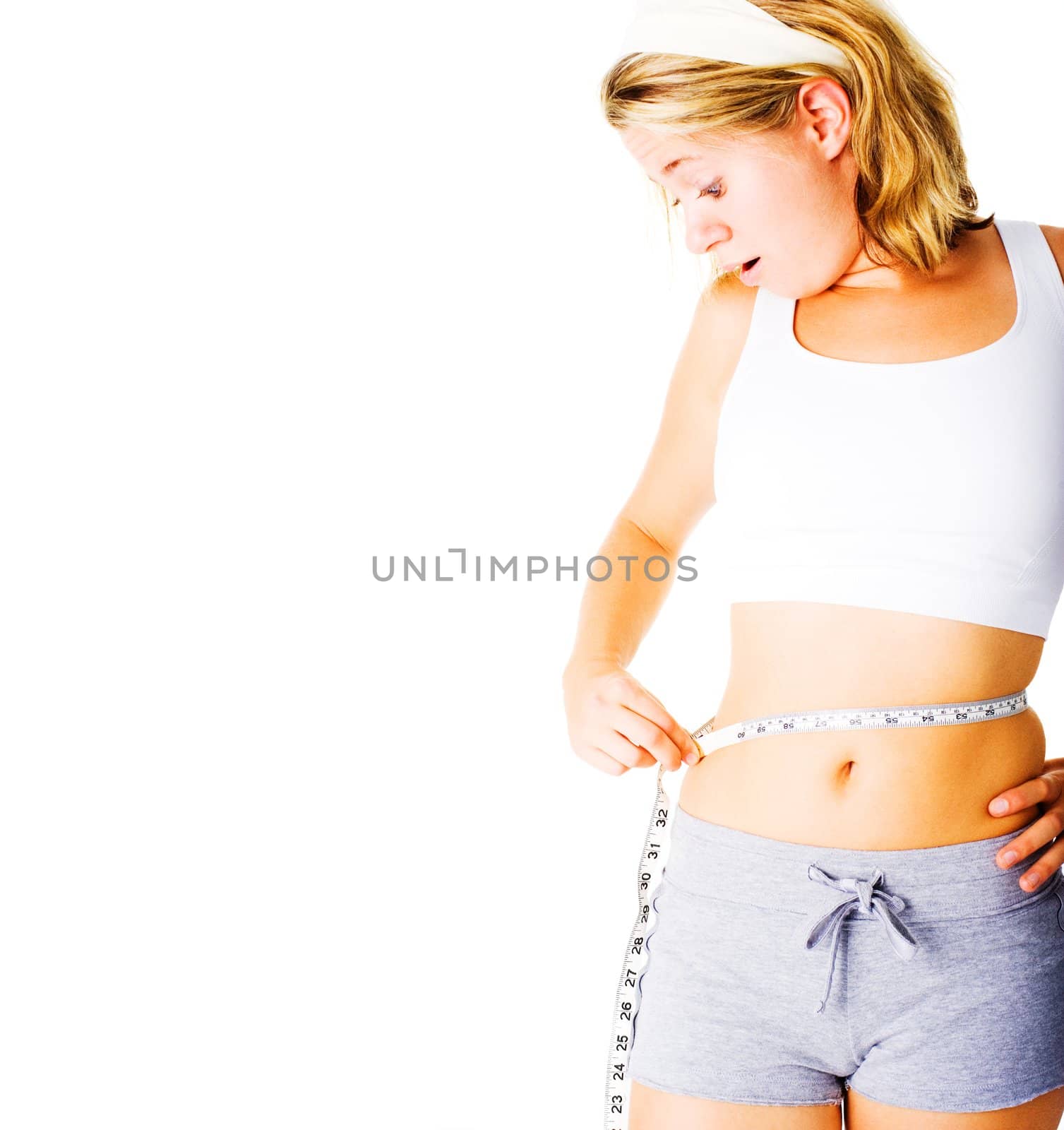 Young woman measuring herself on white, from a complete series of photos.