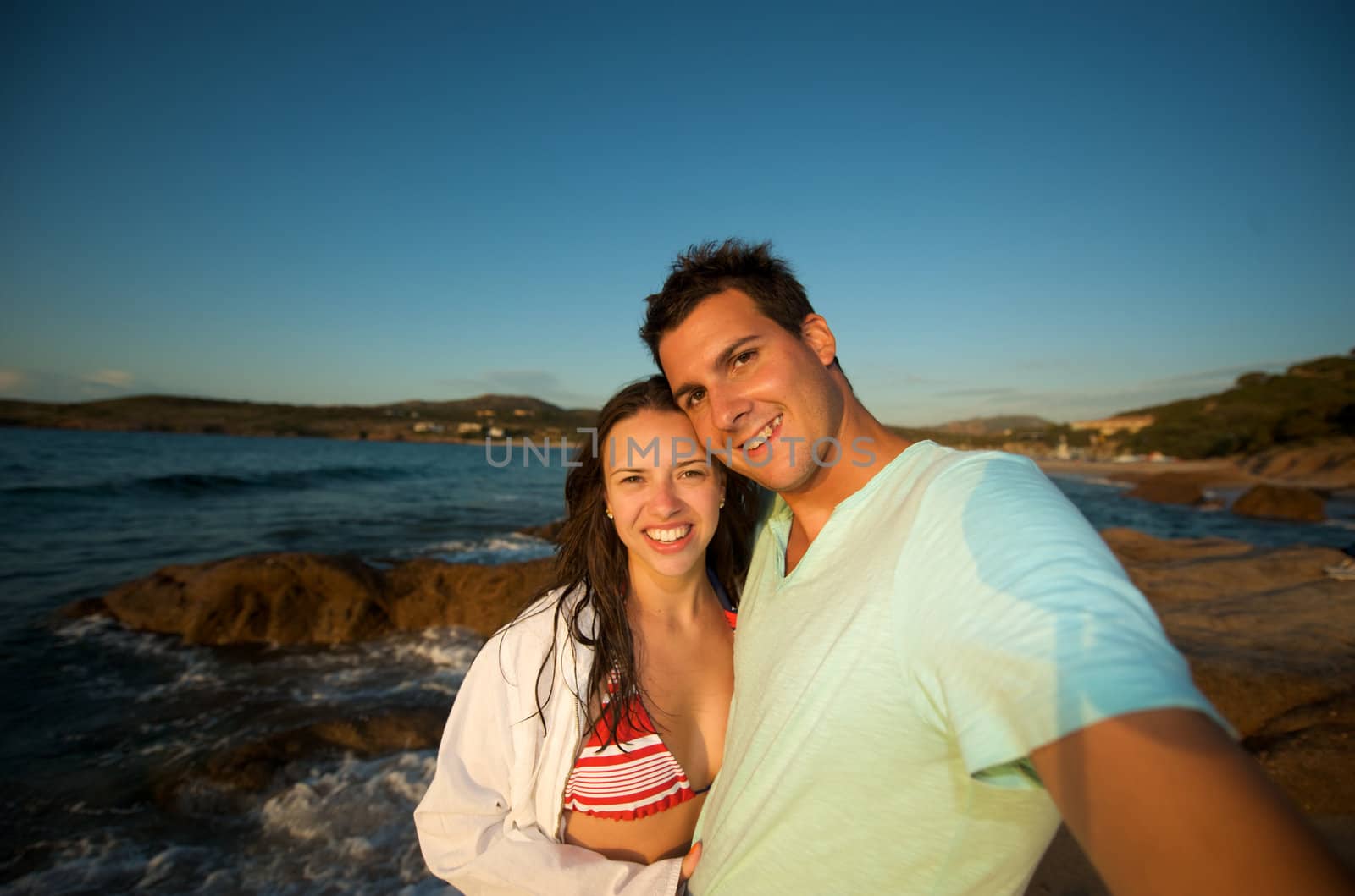 Love couple enjoying the sunset on the beach