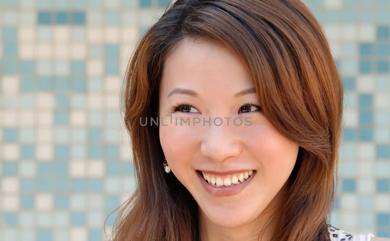 beautiful Asian lady in front of mosaic and smile by elwynn