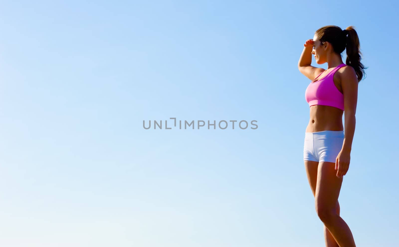 Athletic woman working out in a meadow, from a complete series of photos.