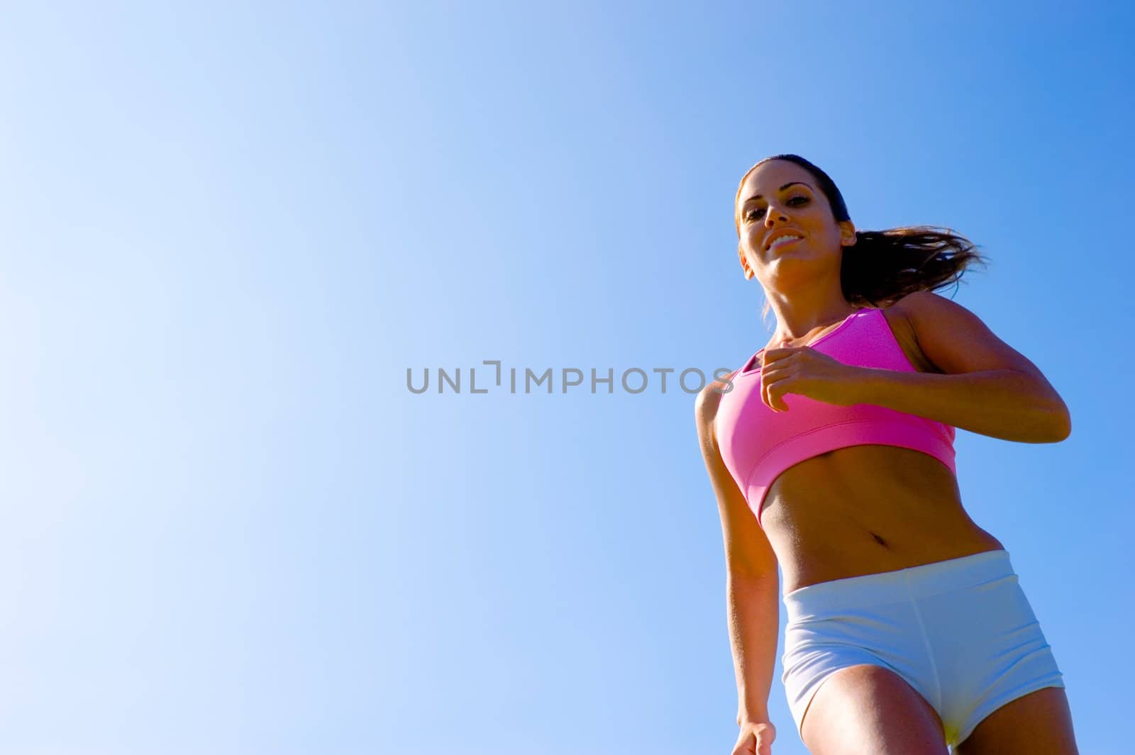 Athletic woman working out in a meadow, from a complete series of photos.