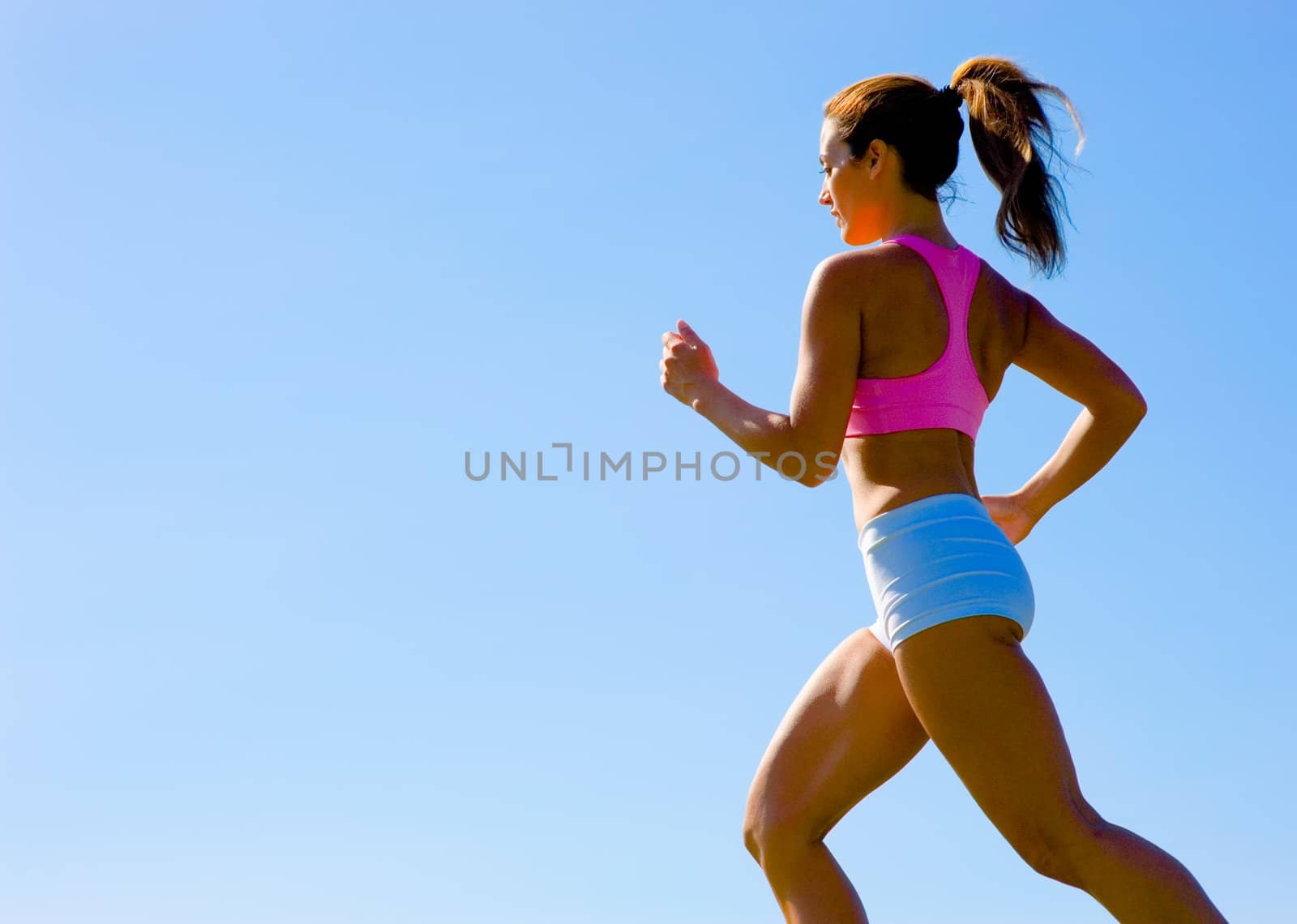 Athletic woman working out in a meadow, from a complete series of photos.