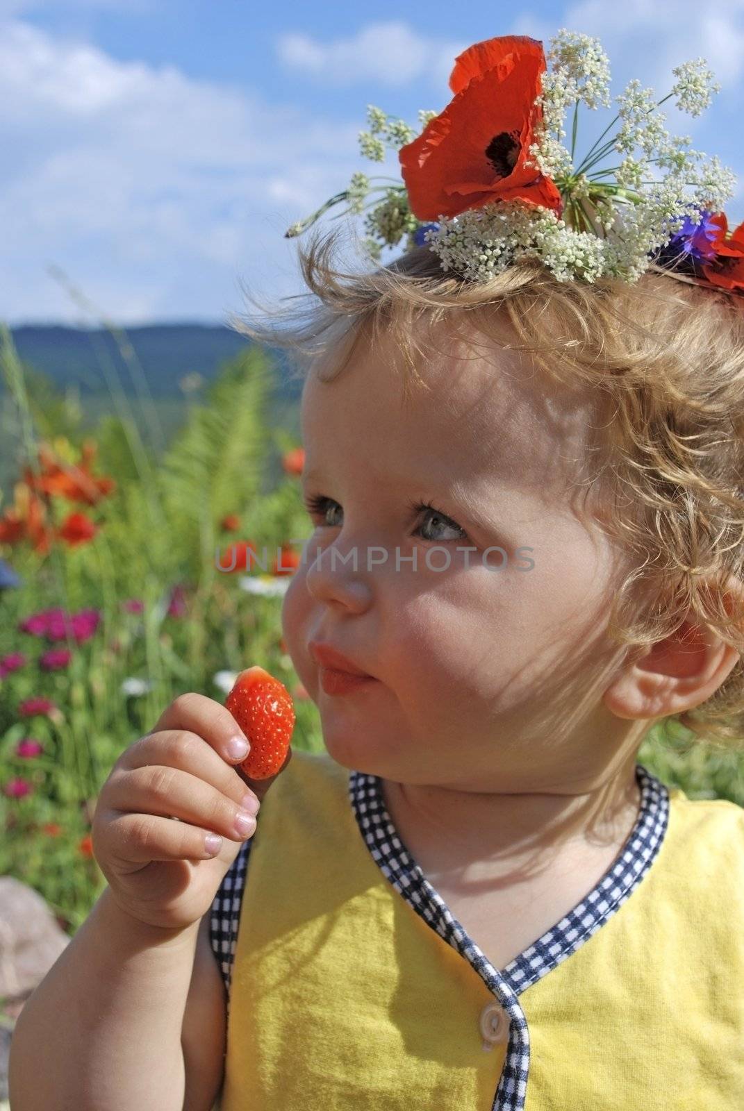 girl eating strawberries, with floral wreath
