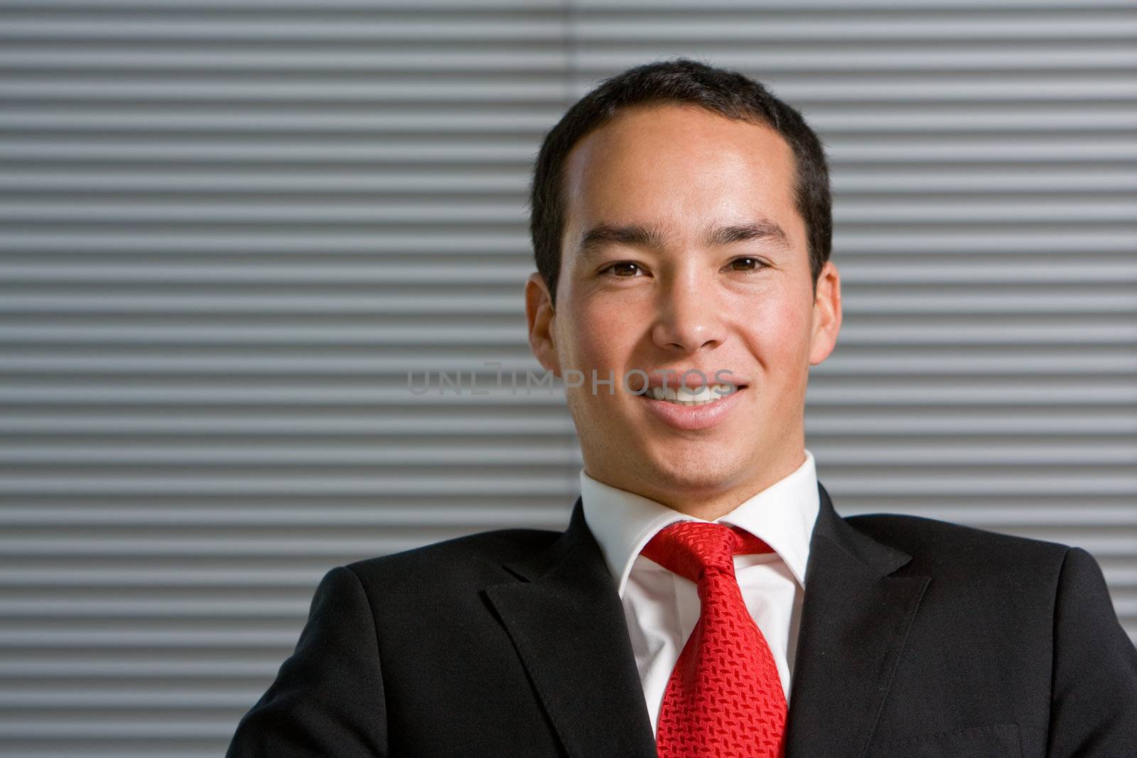 Happy asian business man in formal suit with a large smile