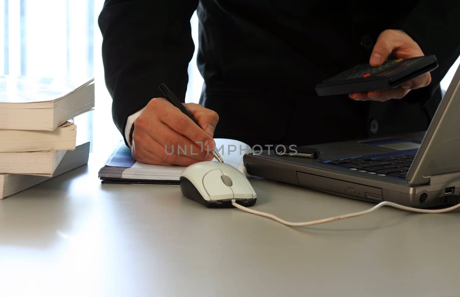 Businessman with laptop and calculator