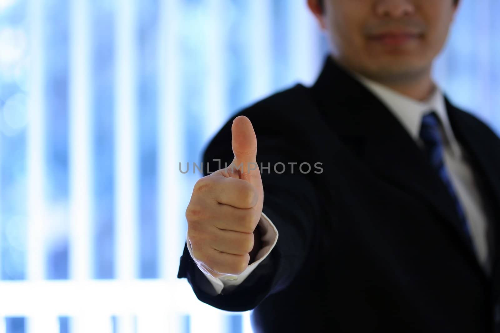 Businessman with his thumb up