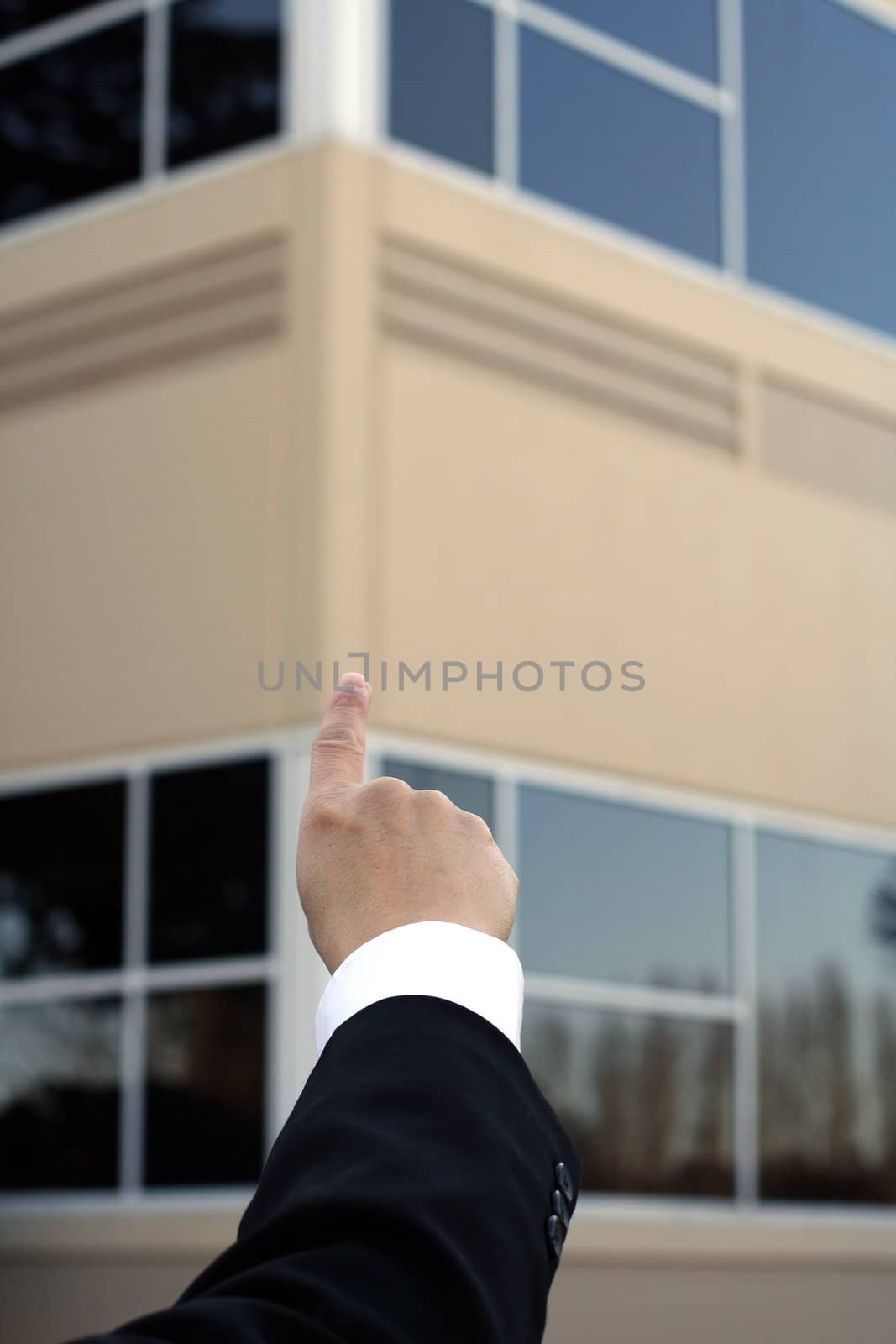 Businessman pointing to a building