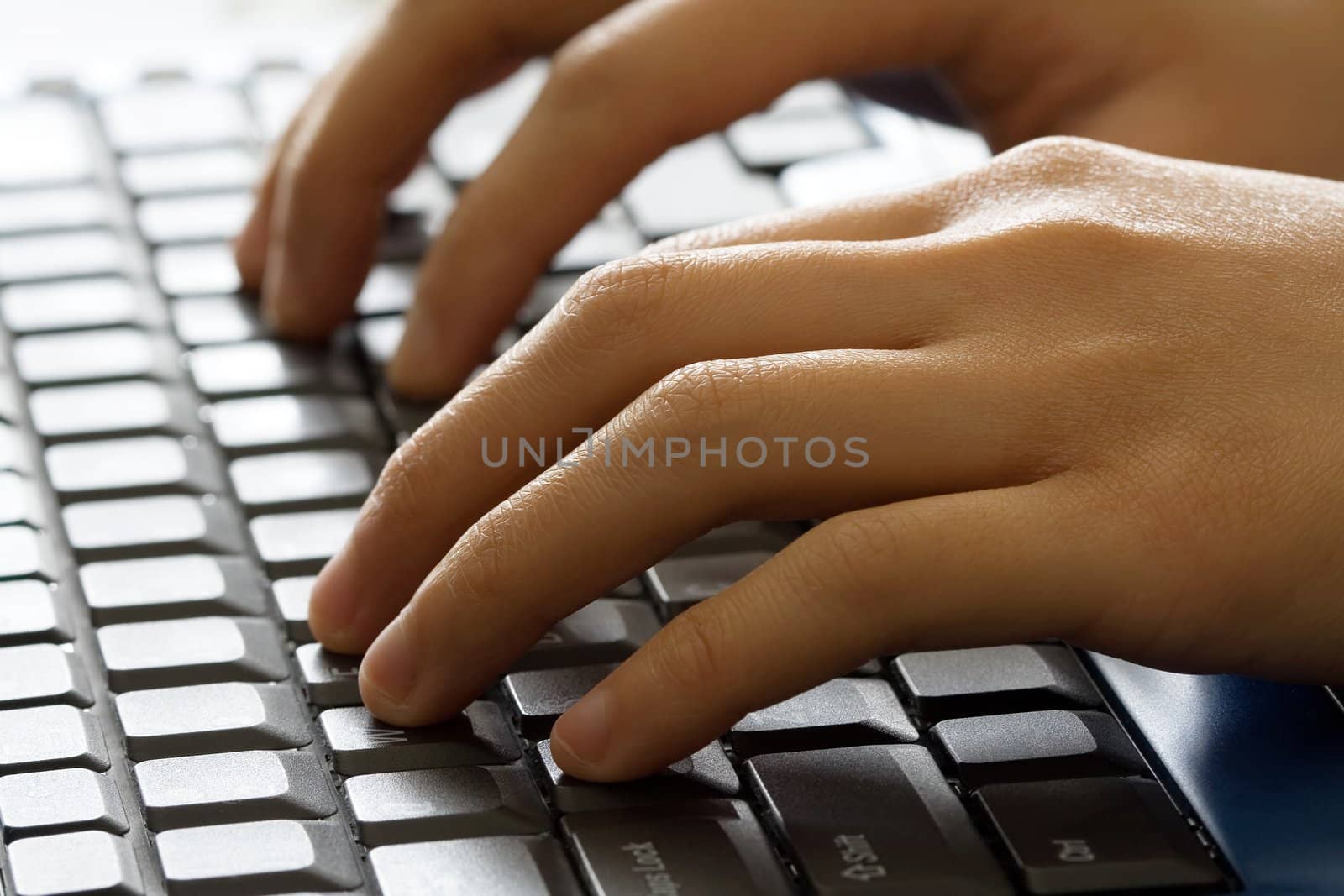 A businessman typing on a laptop