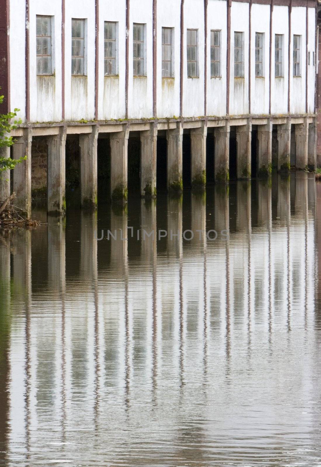 image of the river in a village with reflection of a house