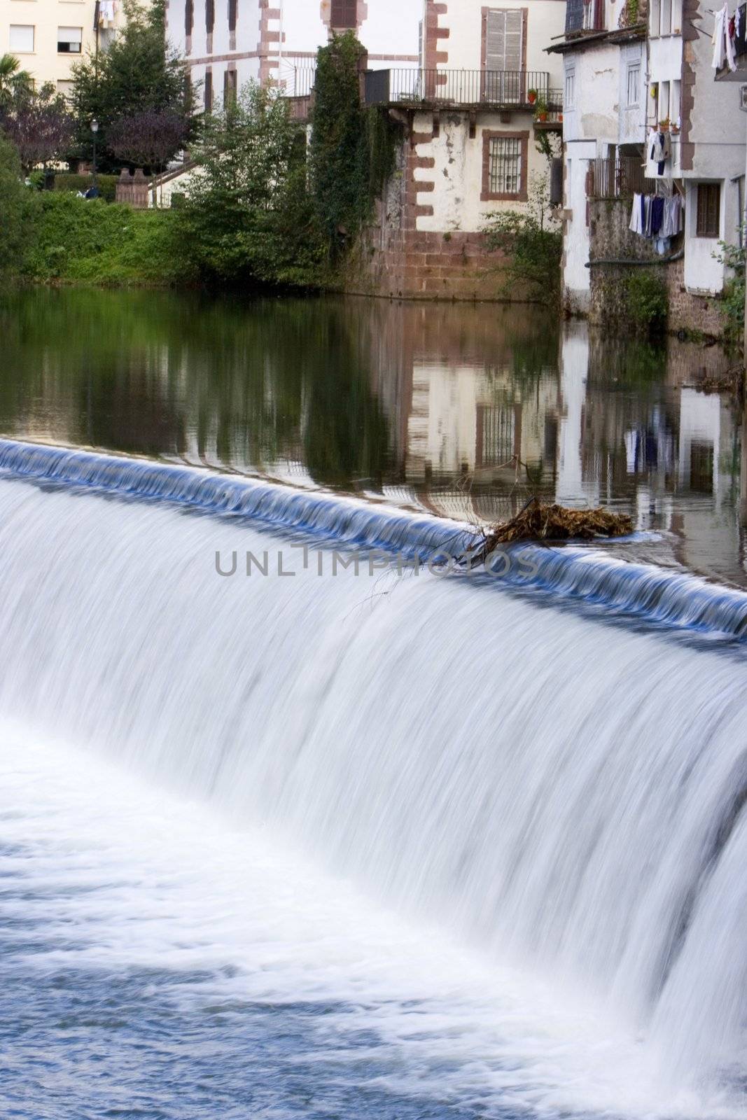 image of the river in a village with reflection of a house