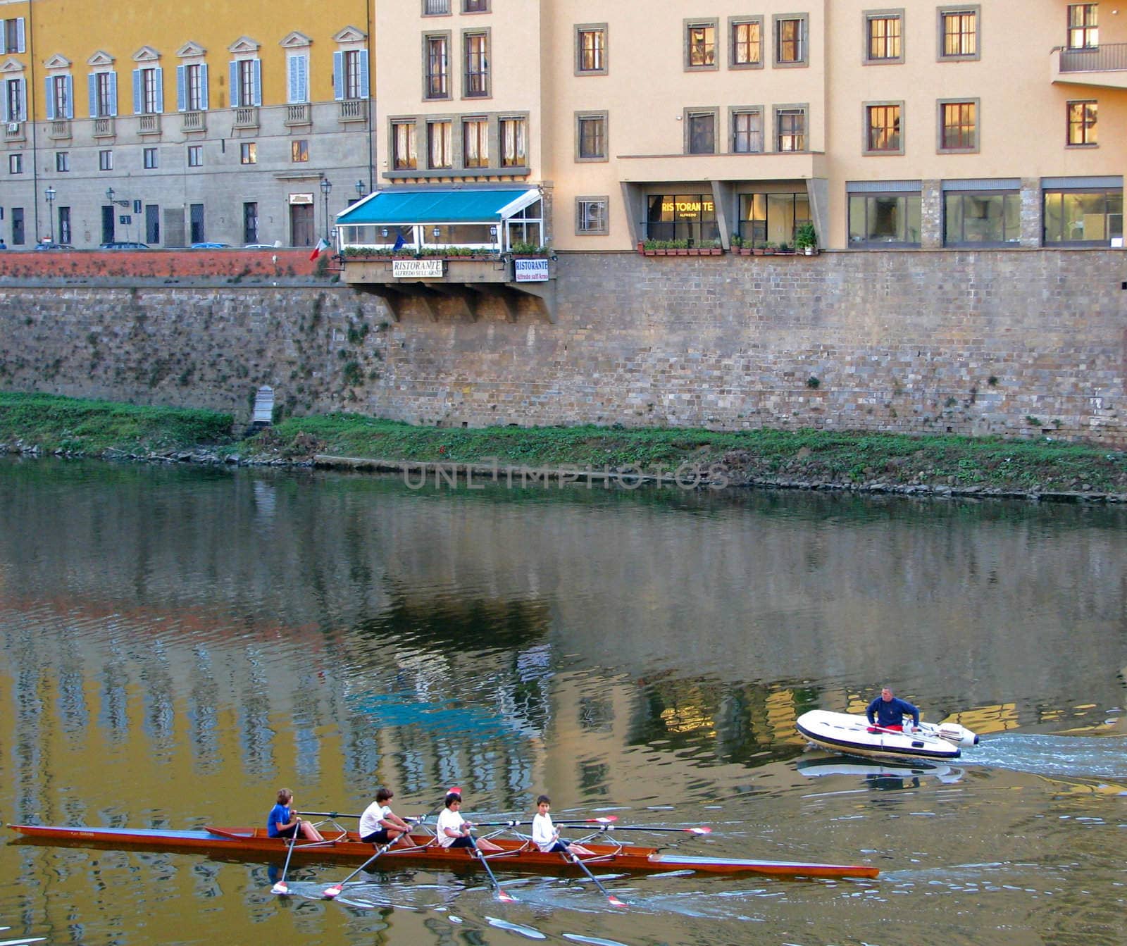 A rowing team practices on the Arno River in Florence, Italy.