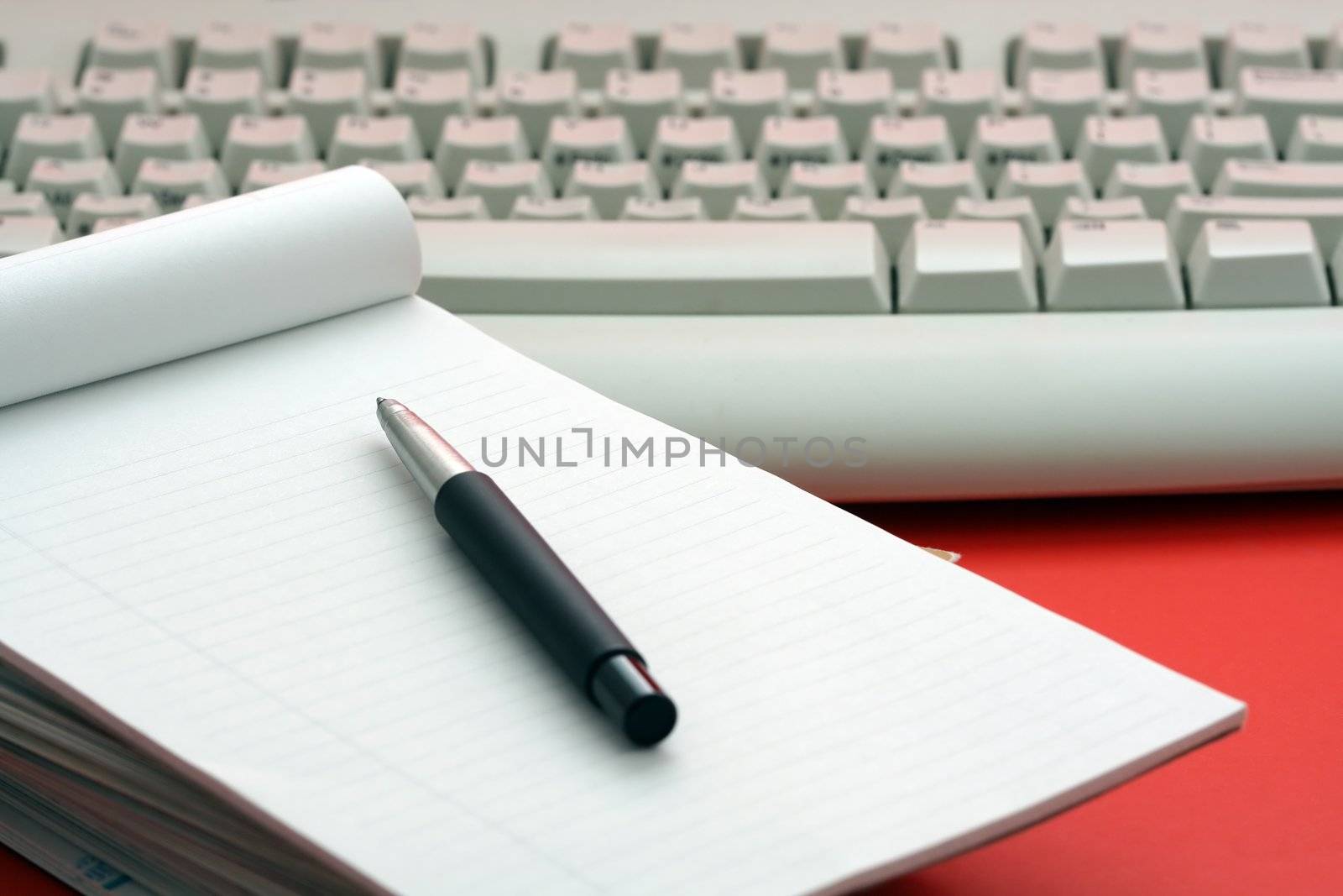Stack of paper and keyboard, symbolizes communication