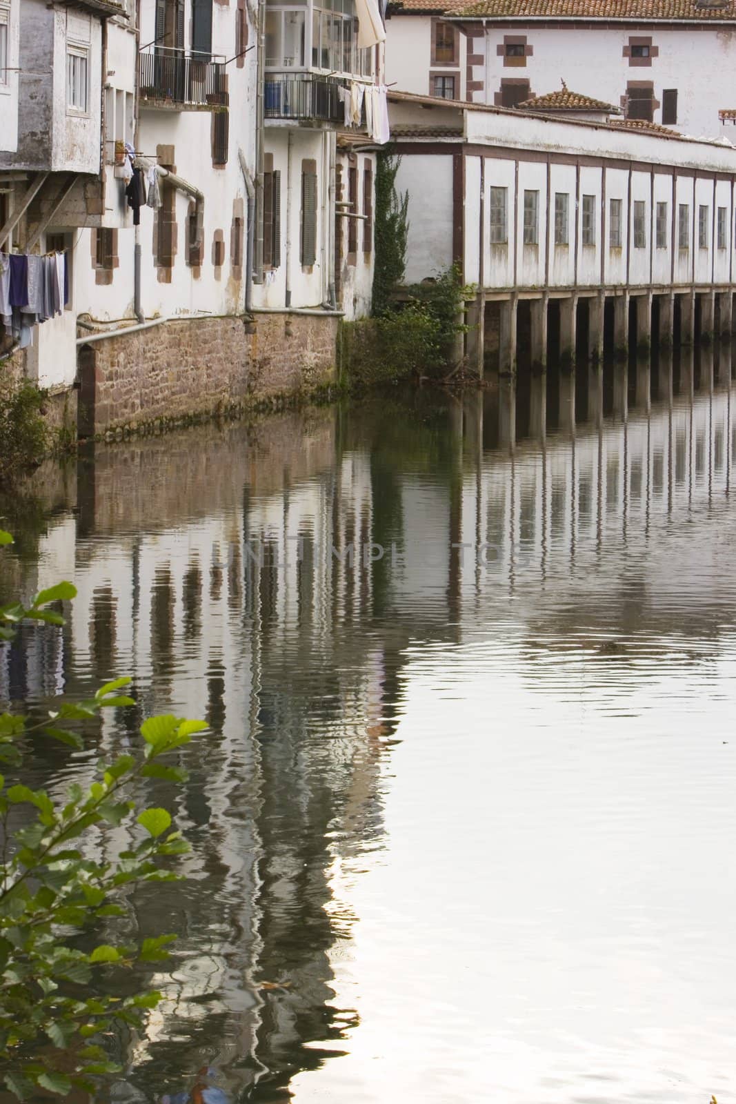 image of the river in a village with reflection of a house